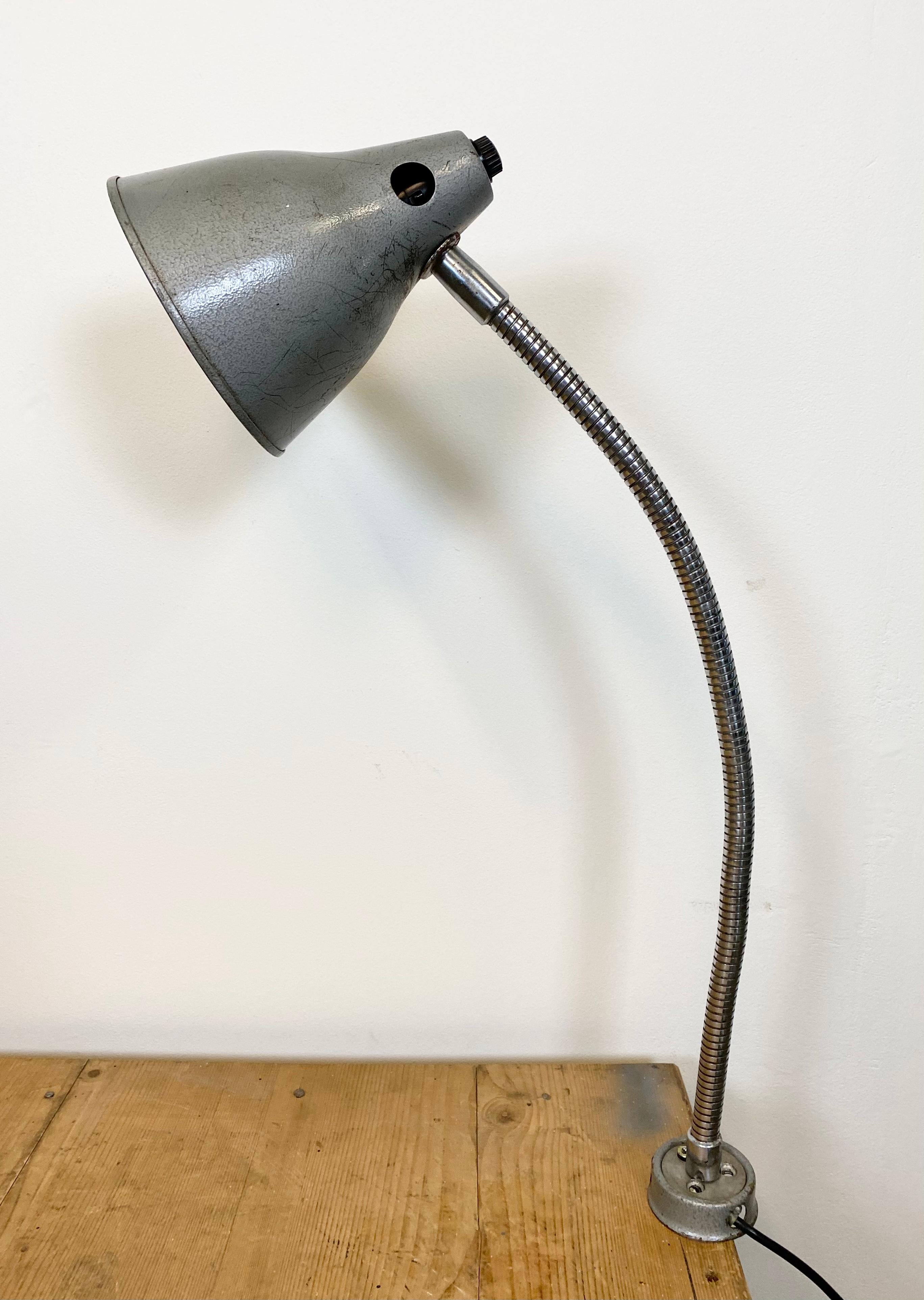 This gooseneck desk lamp was designed and manufactured in Russia during the 1960s. It features a grey hammerpaint shade, a chrome-plated flexible arm and metal base. The switch is situated inside the shade.
Original bakelite socket requires E 27