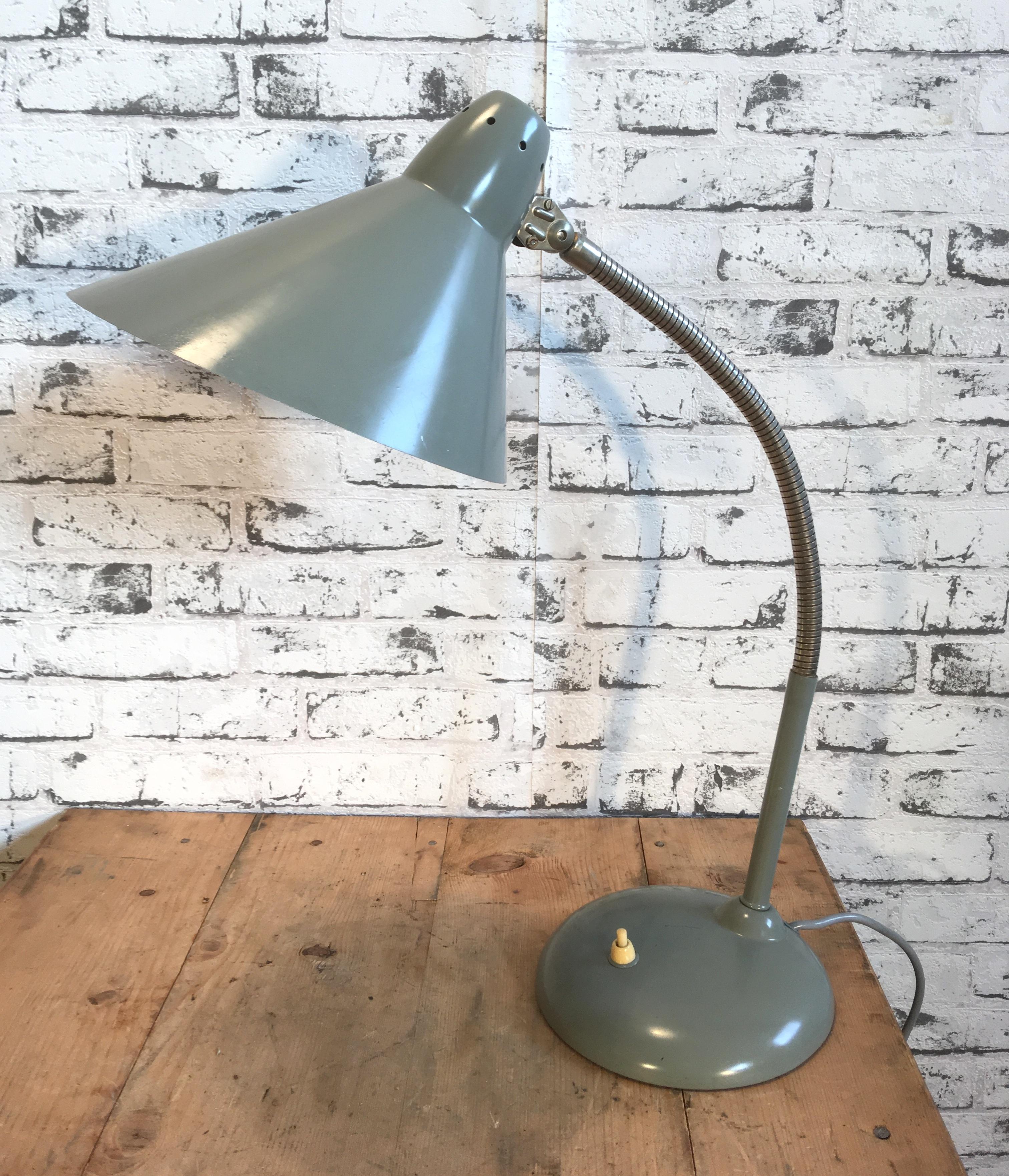 This desk lamp from the 1960s was designed and manufactured by Hala Zeist in the Netherlands. It features a chrome-plated flexible arm, grey metal base and shade.
Socket for E 27 bulbs. Lampshade diameter is 23 cm. Fully functional. Original