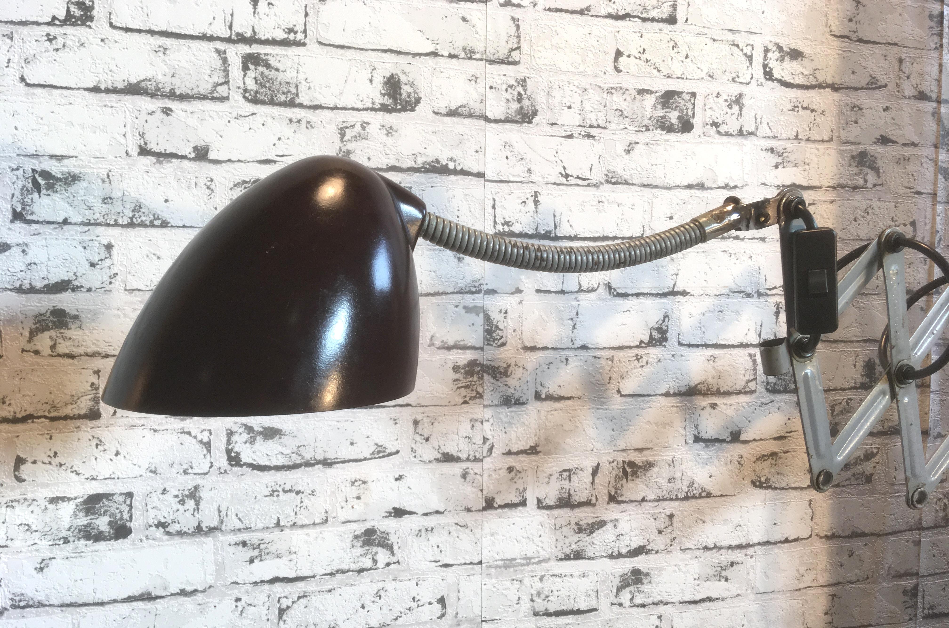 This vintage Industrial scissor lamp was produced by Elektroinstala in former Czechoslovakia in the 1960s. Lamp has brown Bakelite shade. Grey iron scissor arm is extendable and can be turned sideways. Original socket for E 27 bulbs. Fully