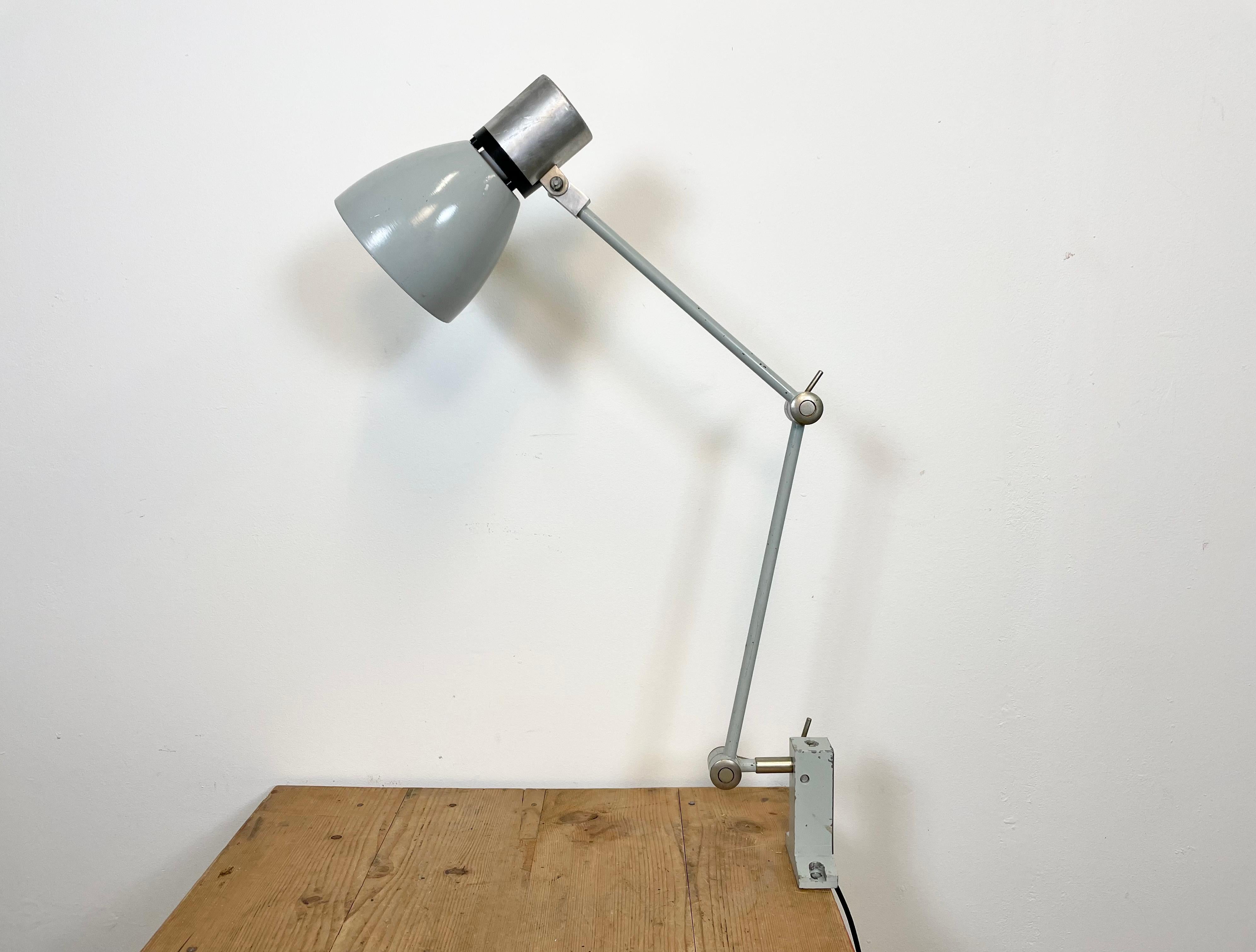 Industrial table lamp made by Elektrosvit in former Czechoslovakia during the 1970s. It features an iron base, an iron arm with three adjustable joints and aluminium shade with original switch on the top. The socket requires E 27 lightbulb. New