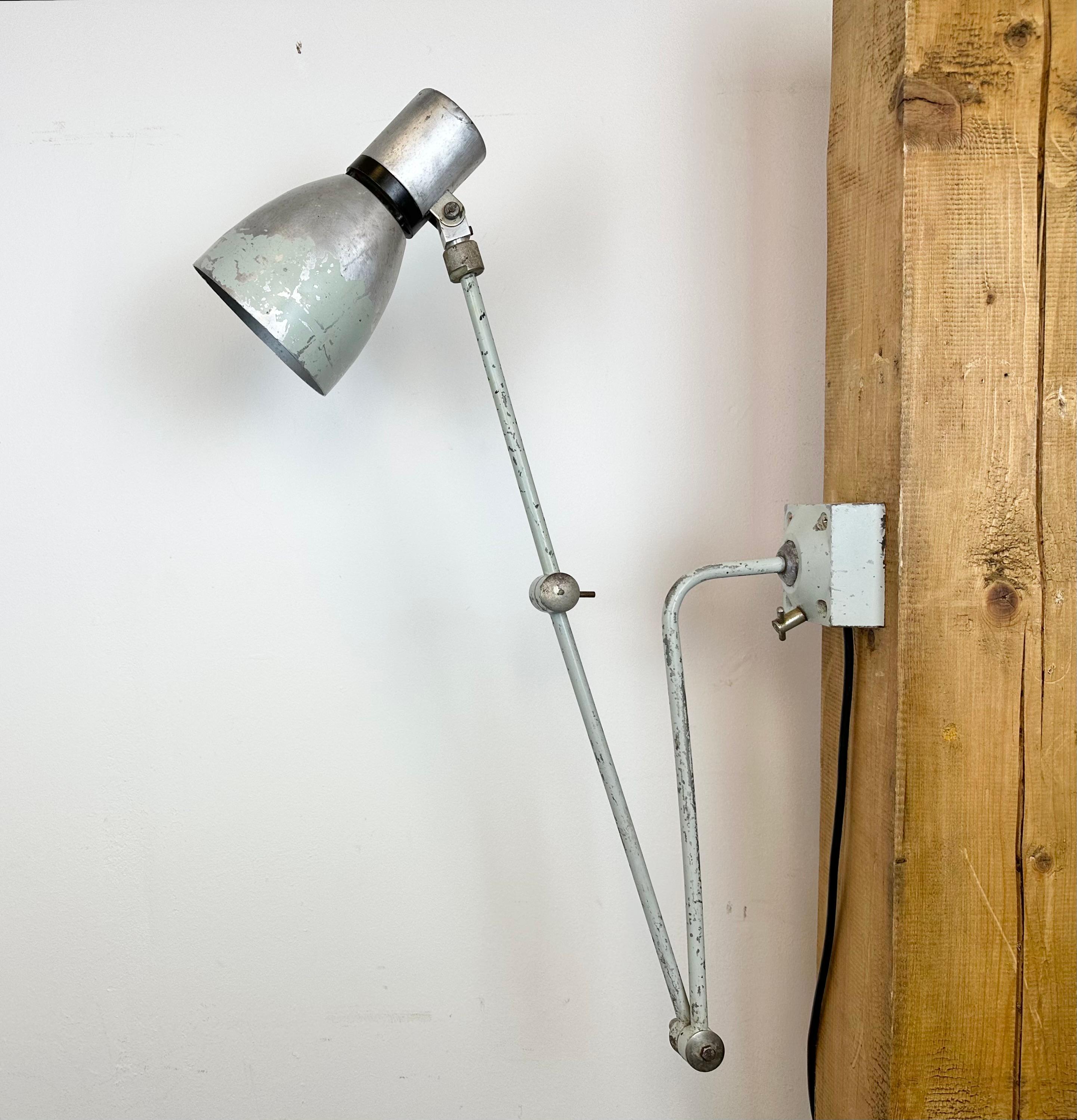 Industrial wall light made by Elektrosvit in former Czechoslovakia during the 1970s. It features an iron base, an iron arm with three adjustable joints and aluminium shade with original switch on the top. The socket requires standard E 27 / E26
