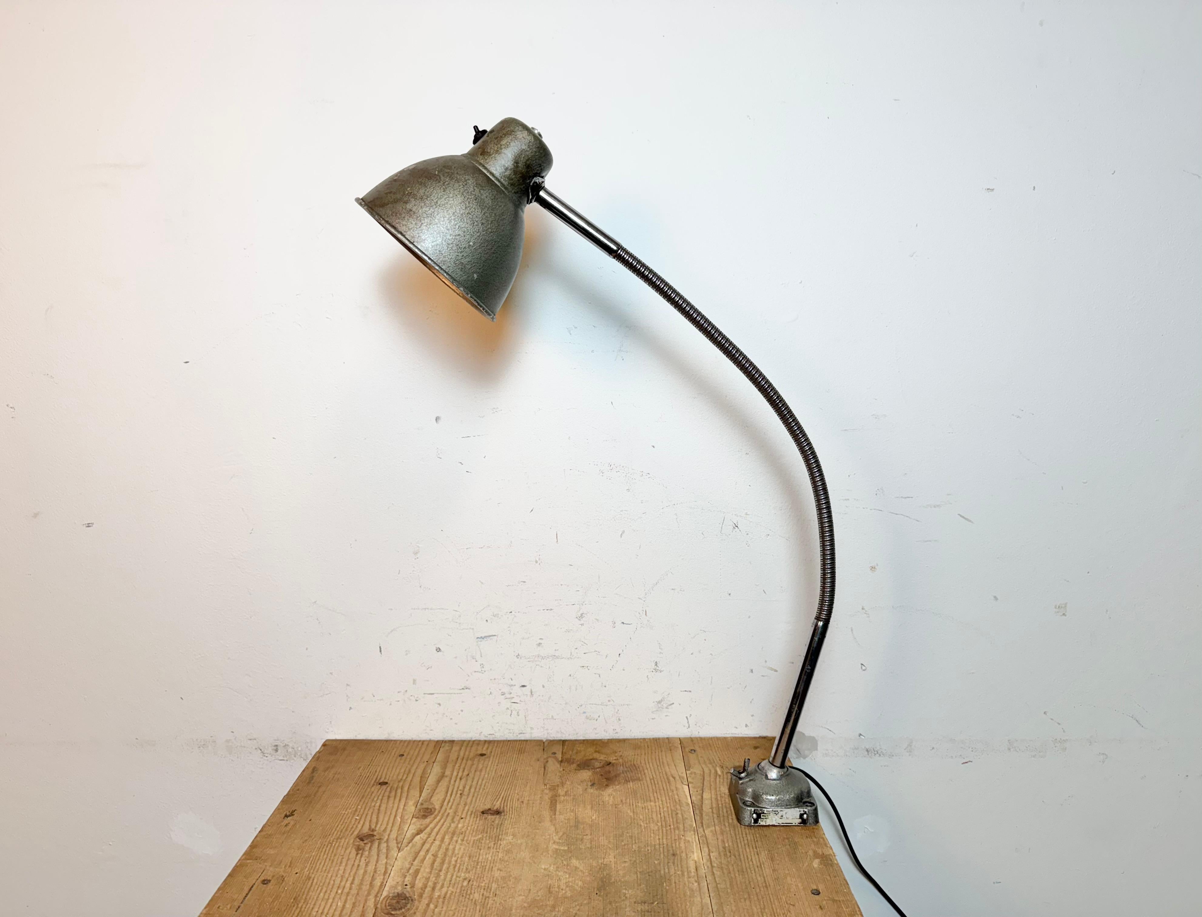 This adjustable gooseneck desk lamp was designed and manufactured in Hungary during the 1960s. It features a green grey hammerpaint metal shade ang base and a chrome-plated flexible arm.The switch is situated directly on the shade.
Original bakelite
