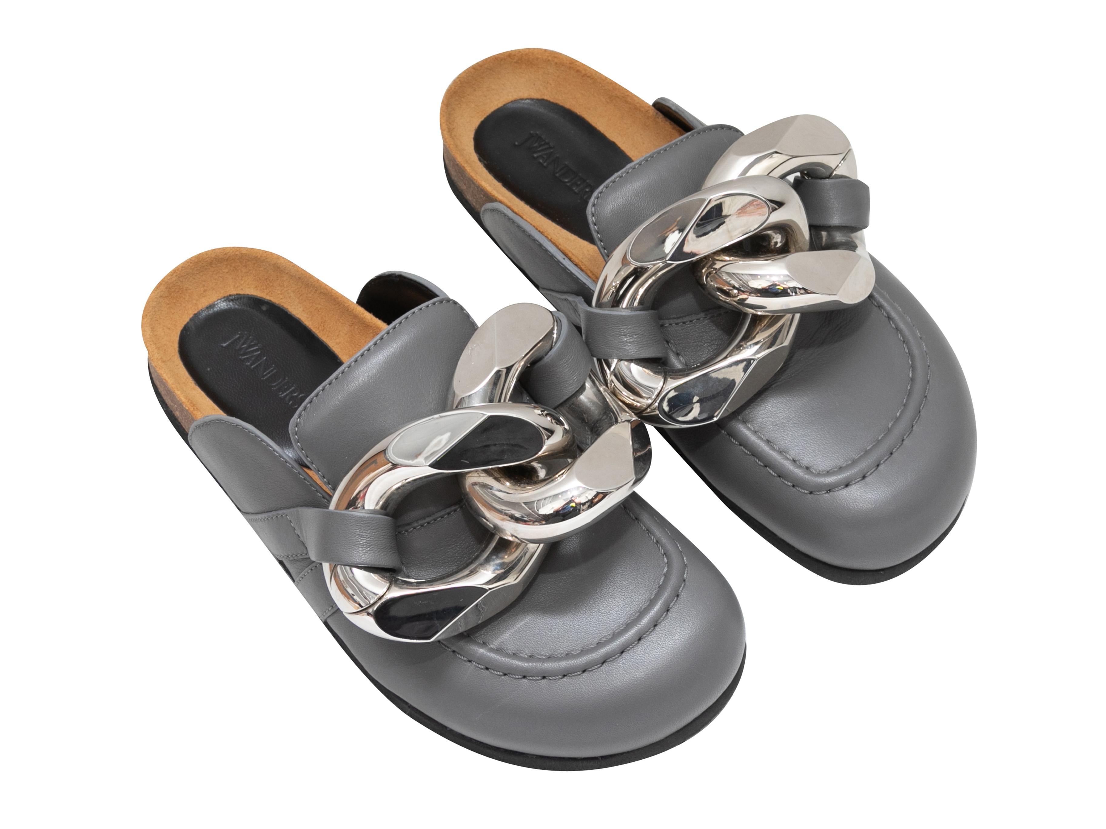 Grey leather flat mules by JW Anderson. Oversized silver-tone chain-link accents at tops. 0.5