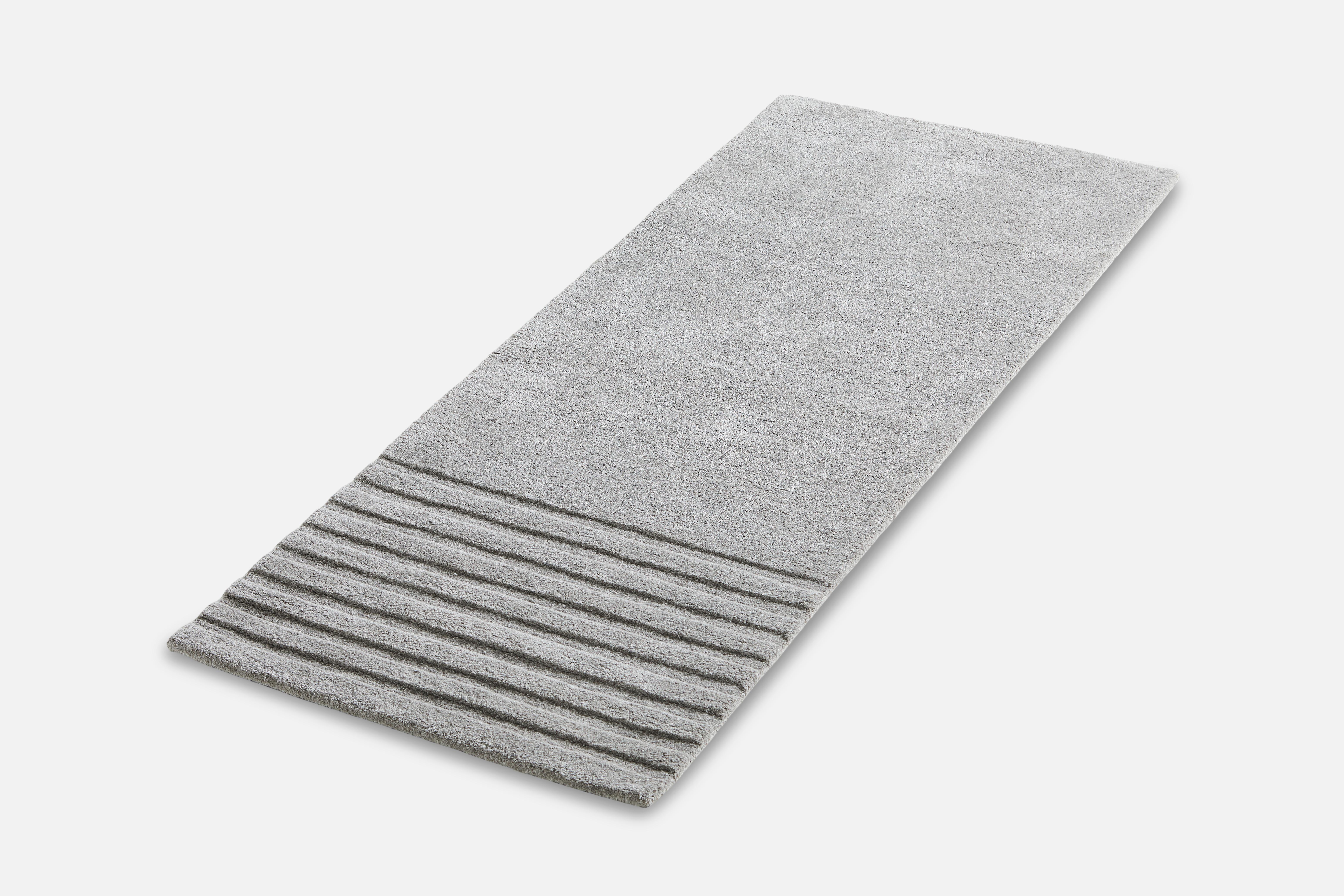 Grey Kyoto rug II by AD Miller.
Materials: 80% wool, 20% cotton.
Dimensions: W 200 x L 80 cm
Available in grey or off white.

The hand-tufted wool rug, Kyoto, takes its inspiration from the distinctive pattern found in traditional raked