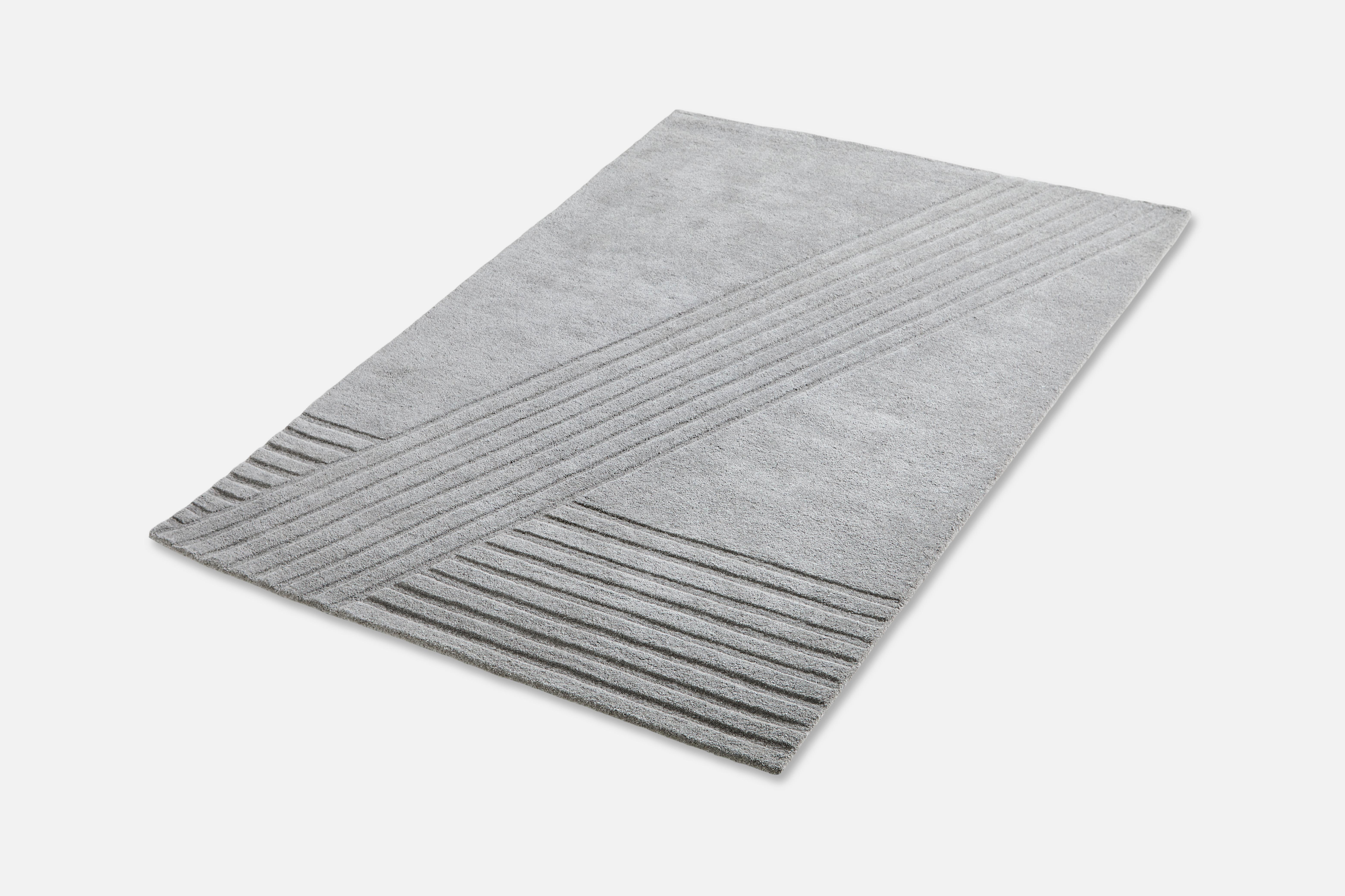 Grey Kyoto rug III by AD Miller.
Materials: 80% wool, 20% cotton.
Dimensions: W 170 x L 240 cm
Available in grey or off white.

The hand-tufted wool rug, Kyoto, takes its inspiration from the distinctive pattern found in traditional raked
