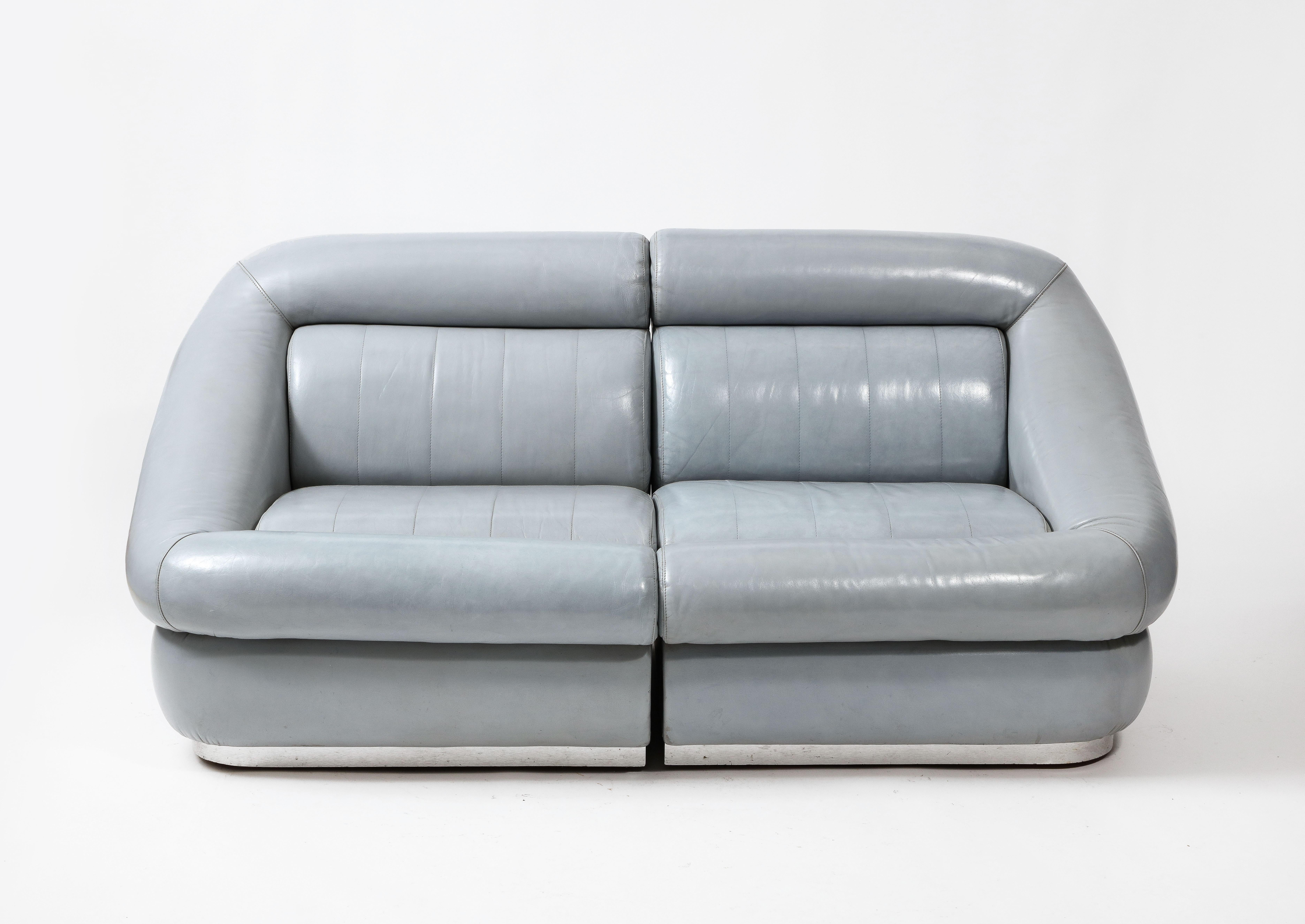Elegant et confortable canapé deux pièces en cuir gris d'origine sur des piétements revêtus d'aluminium. 

Le cuir a été remis à neuf par des professionnels.

Deux canapés assortis sont disponibles. Ils sont vendus à l'unité.