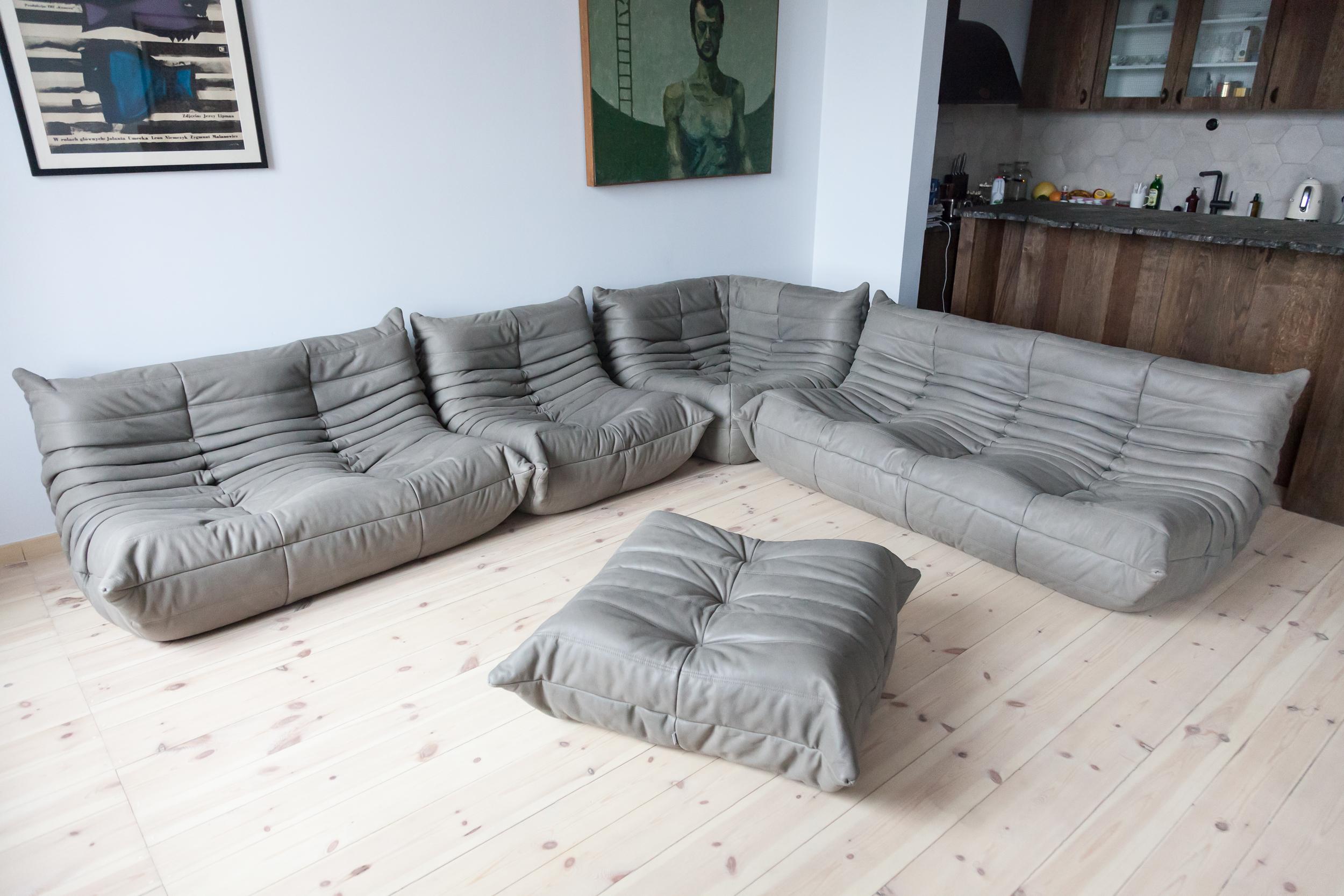This Togo living room set was designed by Michel Ducaroy in 1973 and was manufactured by Ligne Roset in France. It has been reupholstered in new elephant grey leather and is made up of the following pieces: One three-seat couch (70 x 174 x 102 cm),
