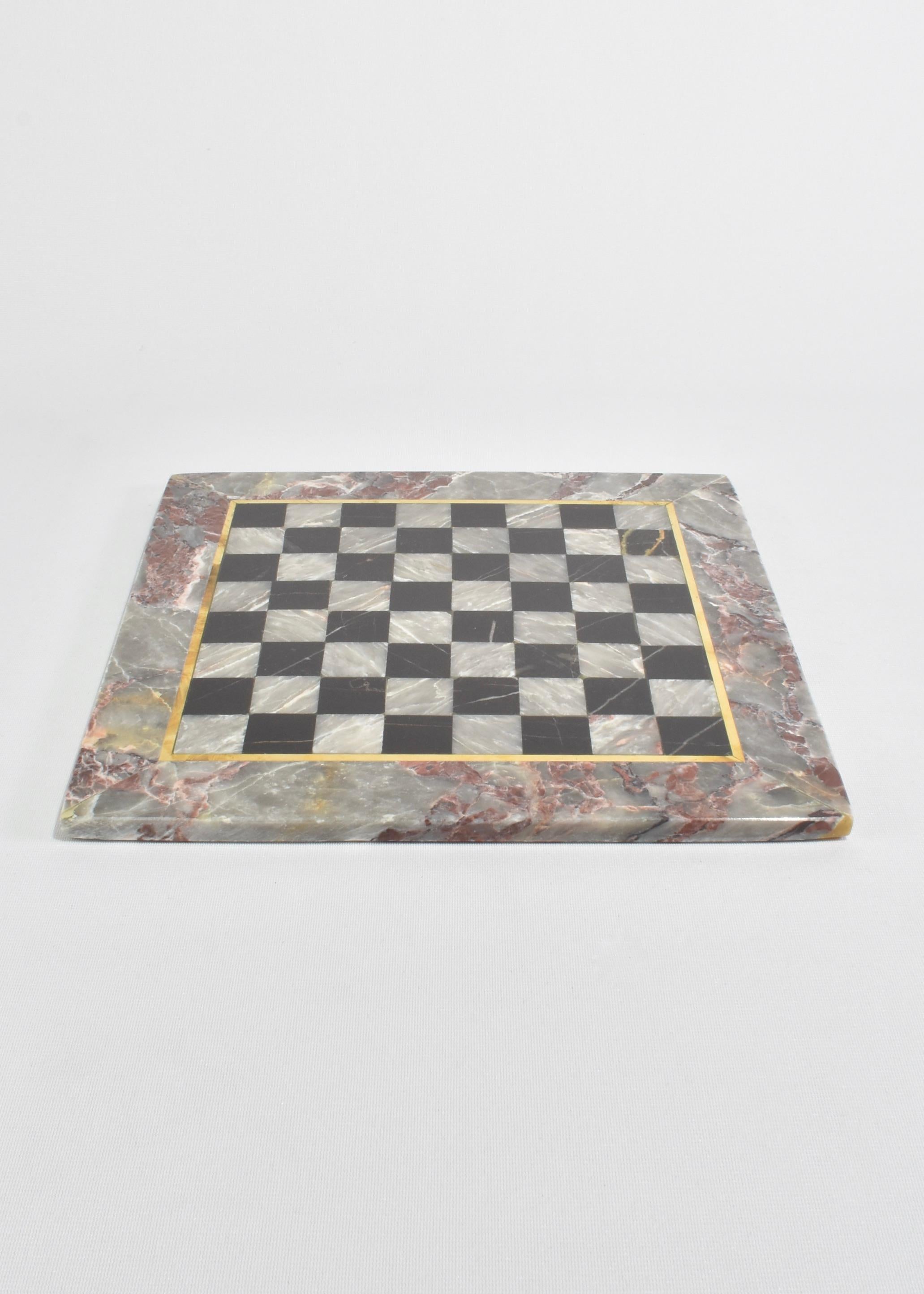 Beautiful vintage grey and black marble chess board with brass inlay and 32 chess pieces.