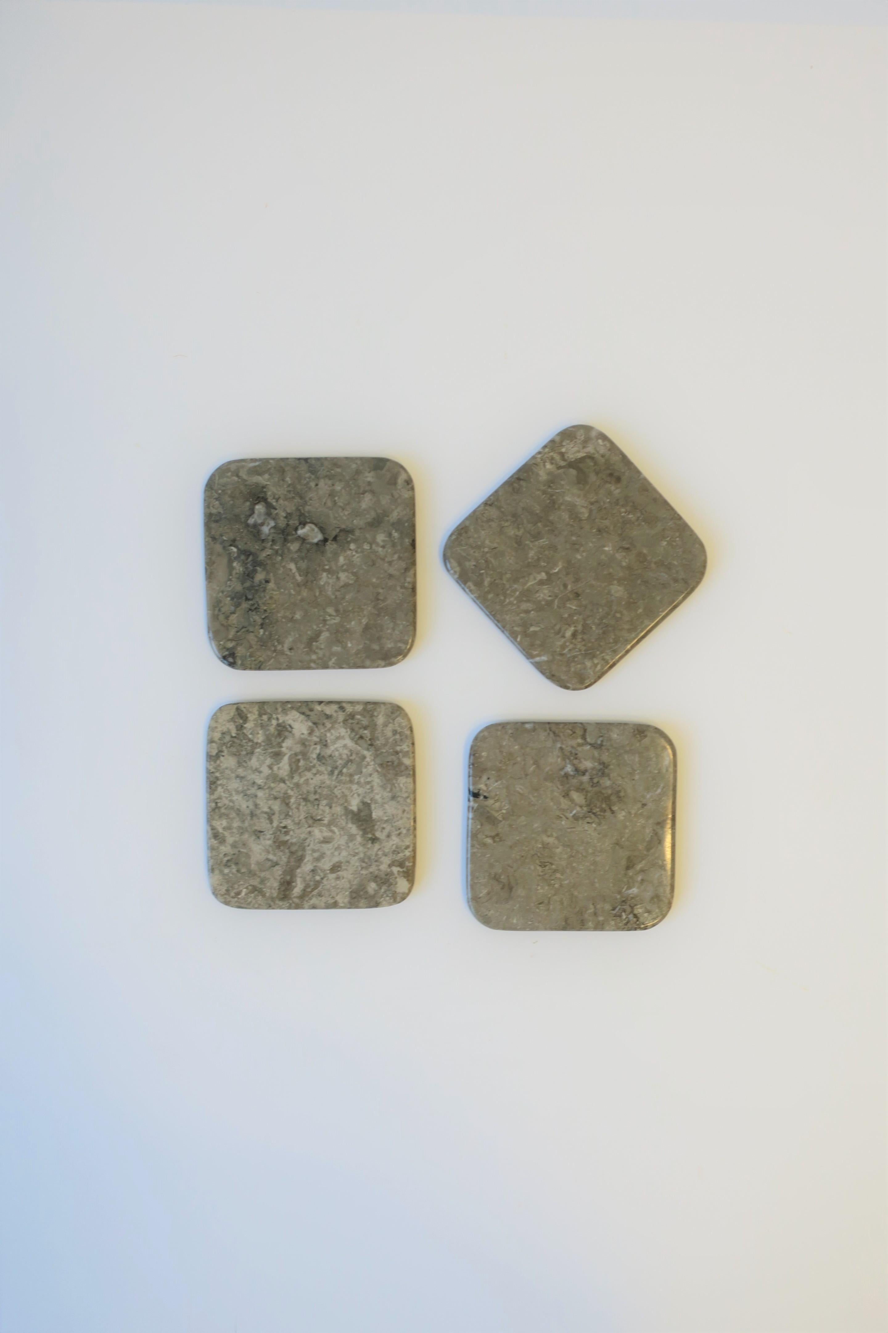 A great set of four (4) Modern style or Postmodern period grey-taupe marble stone cocktail or drinks coasters, circa late 20th century, 1980s-1990s. Set's shape is square with round corners.

Dimensions: 4