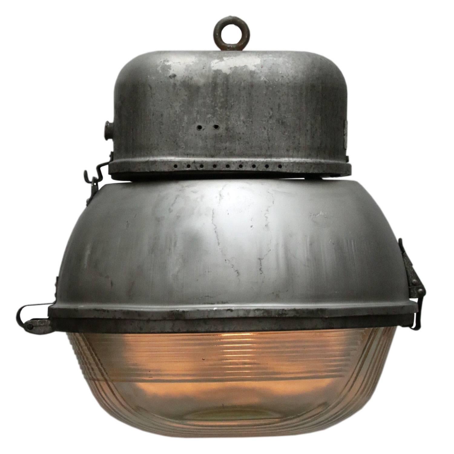 Oval factory / street light. Aluminium with slight light green Holophane glass. 

Weight: 5.5 kg / 12.1 lb

All lamps have been made suitable by international standards for incandescent light bulbs, energy-efficient and LED bulbs. E26/E27 bulb