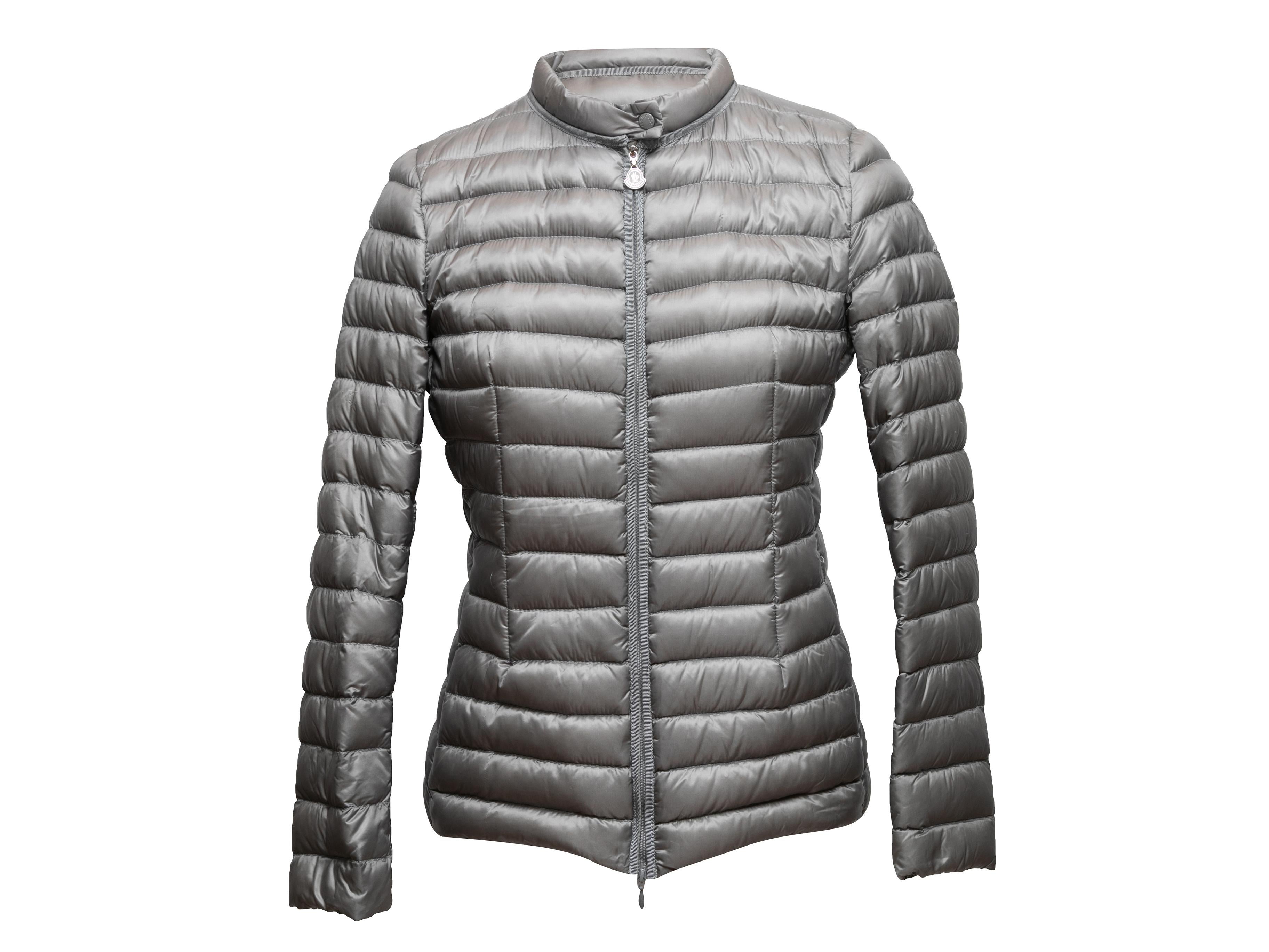 Grey down puffer jacket by Moncler. Crew neck. Zip closure at center front. 32