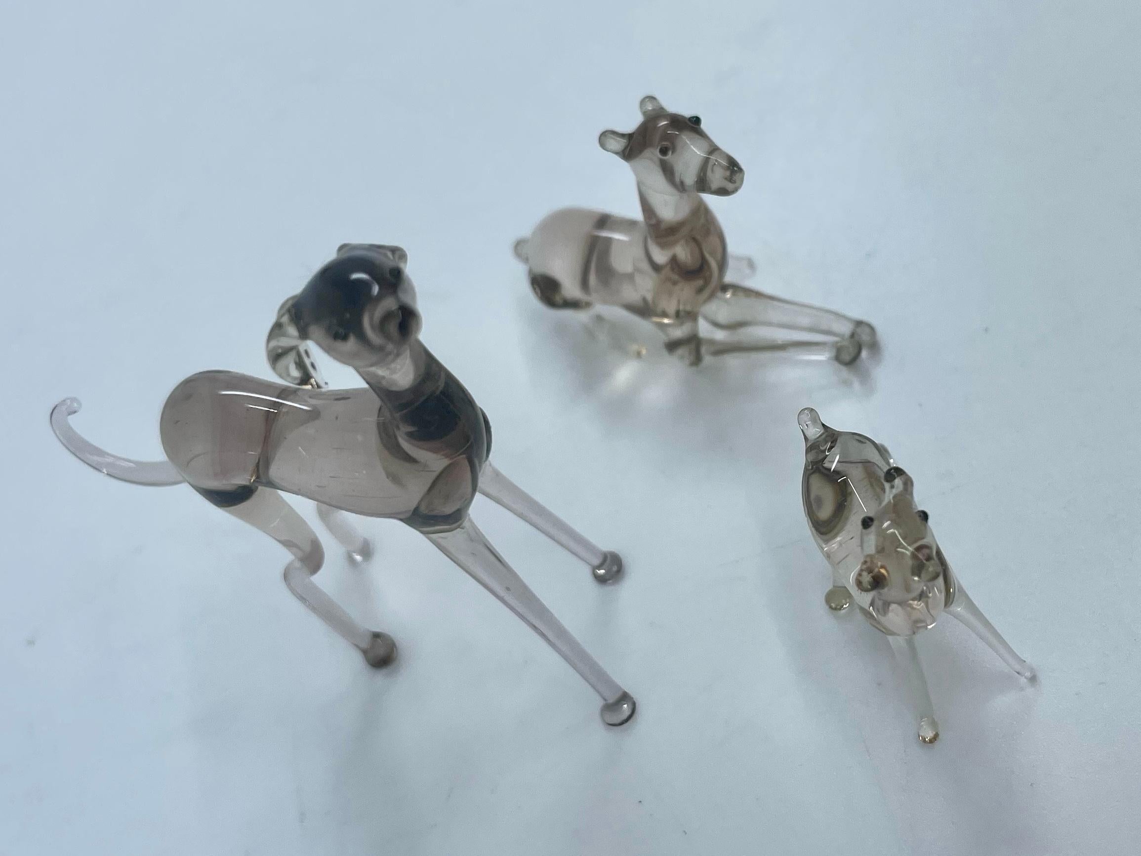 Chiens gris de Murano. Vintage set of fine blown Murano grey glass dogs father mother and puppy, grey hound/ whippet. Italie, années 1940 
Dimensions :
Le plus grand : 2