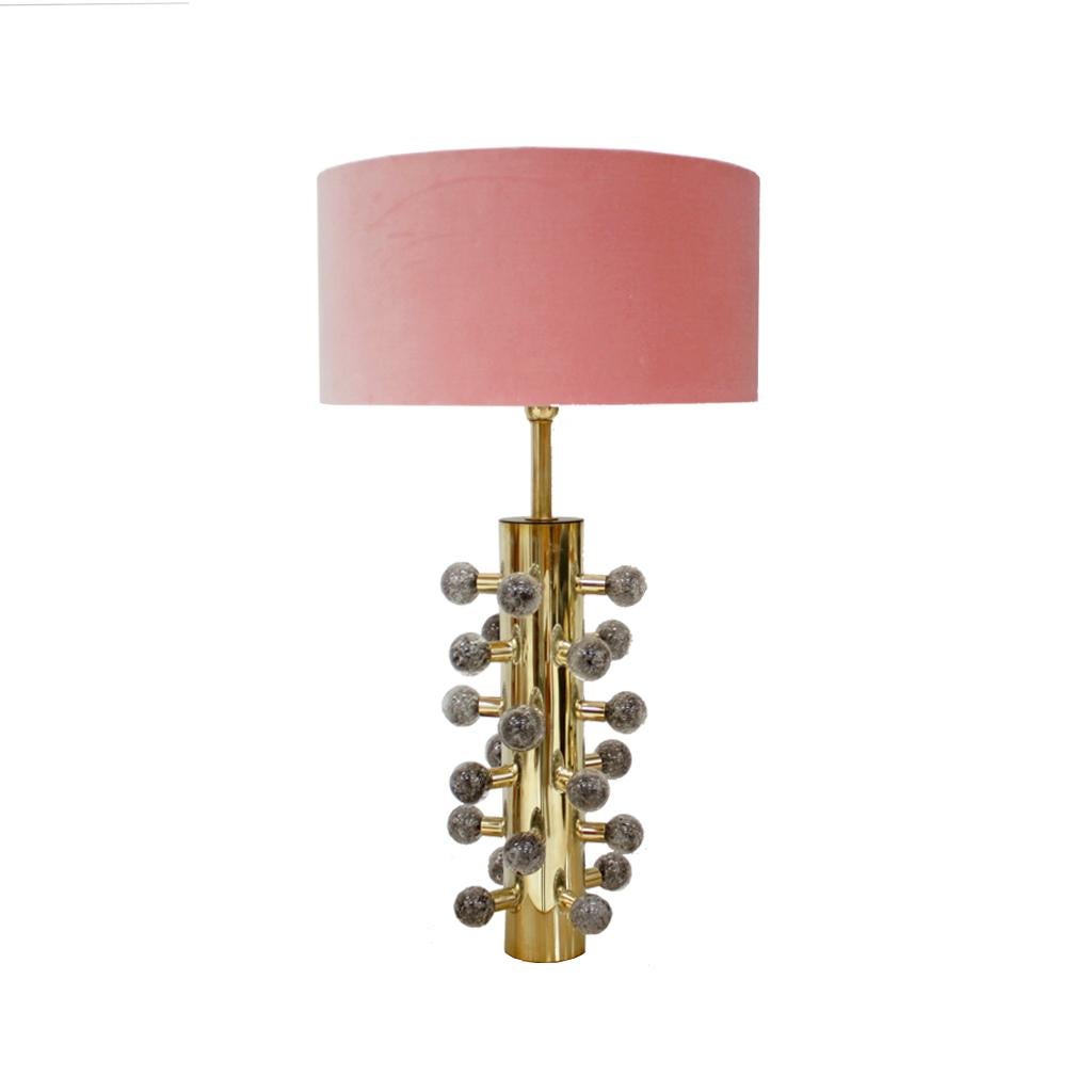 Elevate your space with this exquisite pair of sculptural Italian table lamps. Crafted from polished brass and adorned with elegant grey Murano glass spheres, these lamps exude luxury and sophistication. The sculptural design and meticulous Italian