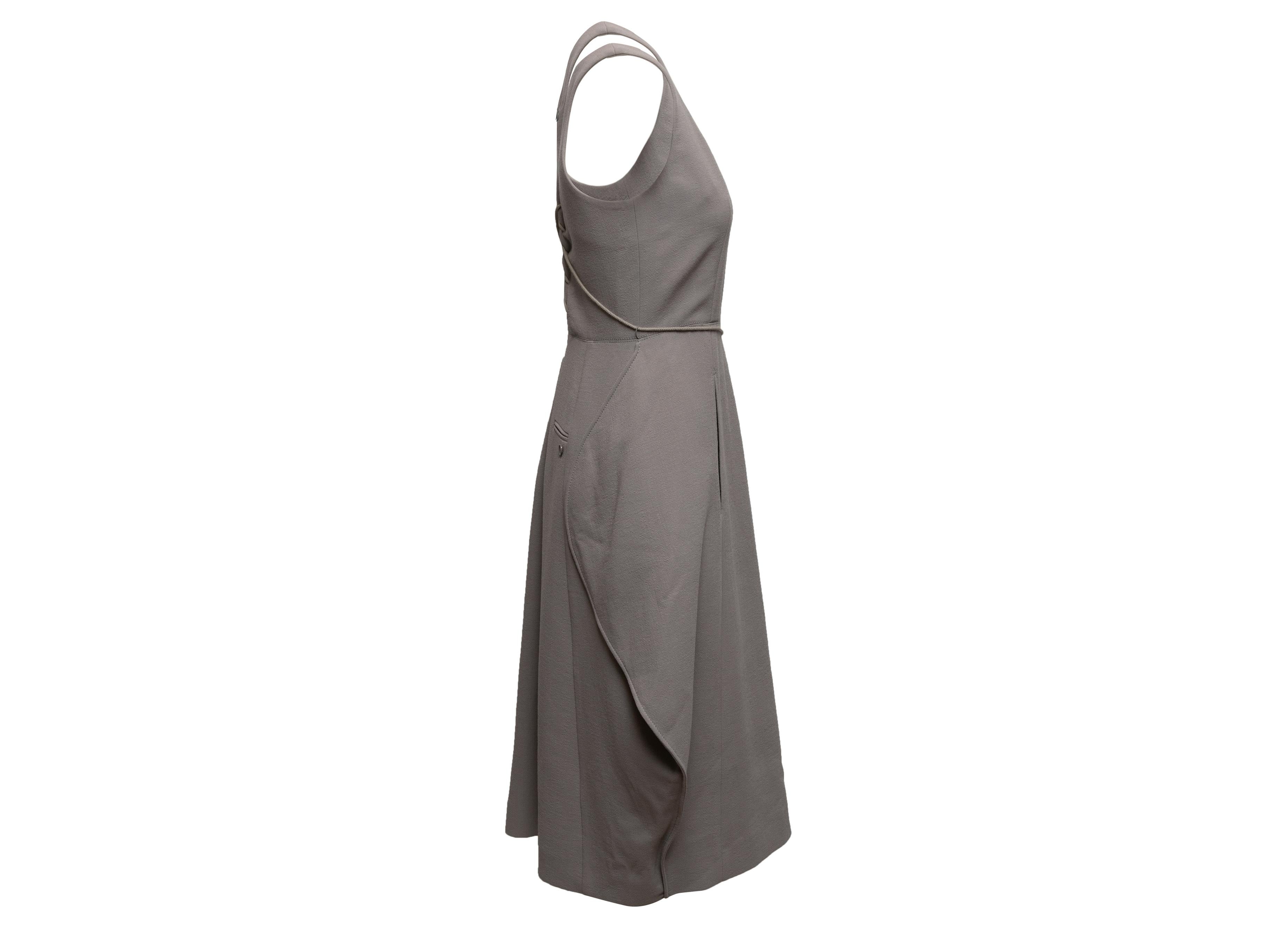 Grey wool sleeveless midi dress by Nina Ricci. Scoop neckline. Lace-up detailing and zip closure at back. 31