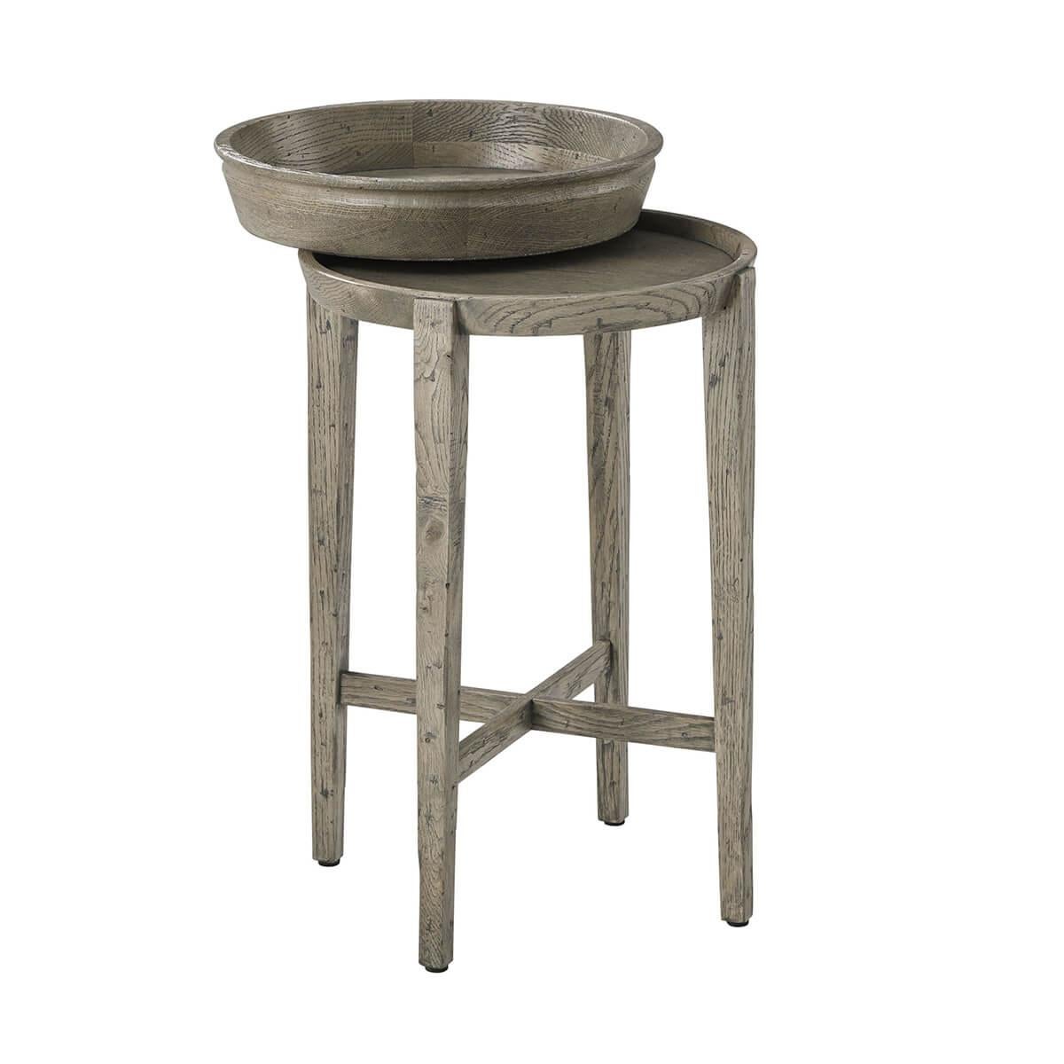In a grey echo oak finish. The small round accent table has a removable bowl form tray top that sits on a base with four square tapered legs joined by an 