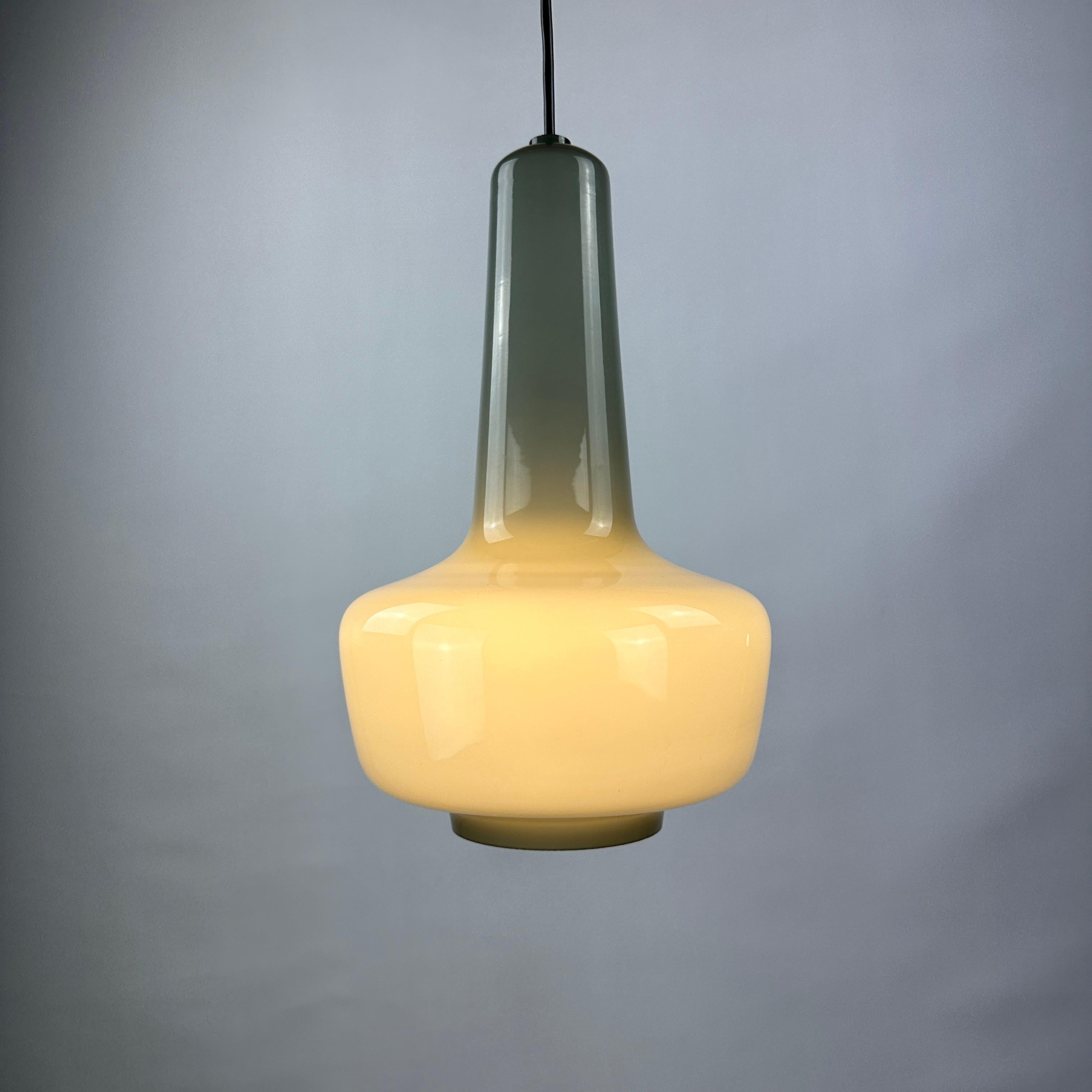 Grey glass pendant light named Kreta designed by Jacob Bang and made by Holmegaard and designed by Fog & Mørup around the 1960's. 

A danish design classic.

This color is more rare on the market.

DIMENSIONS

Height: 38cm
Diameter: 24cm
Cord