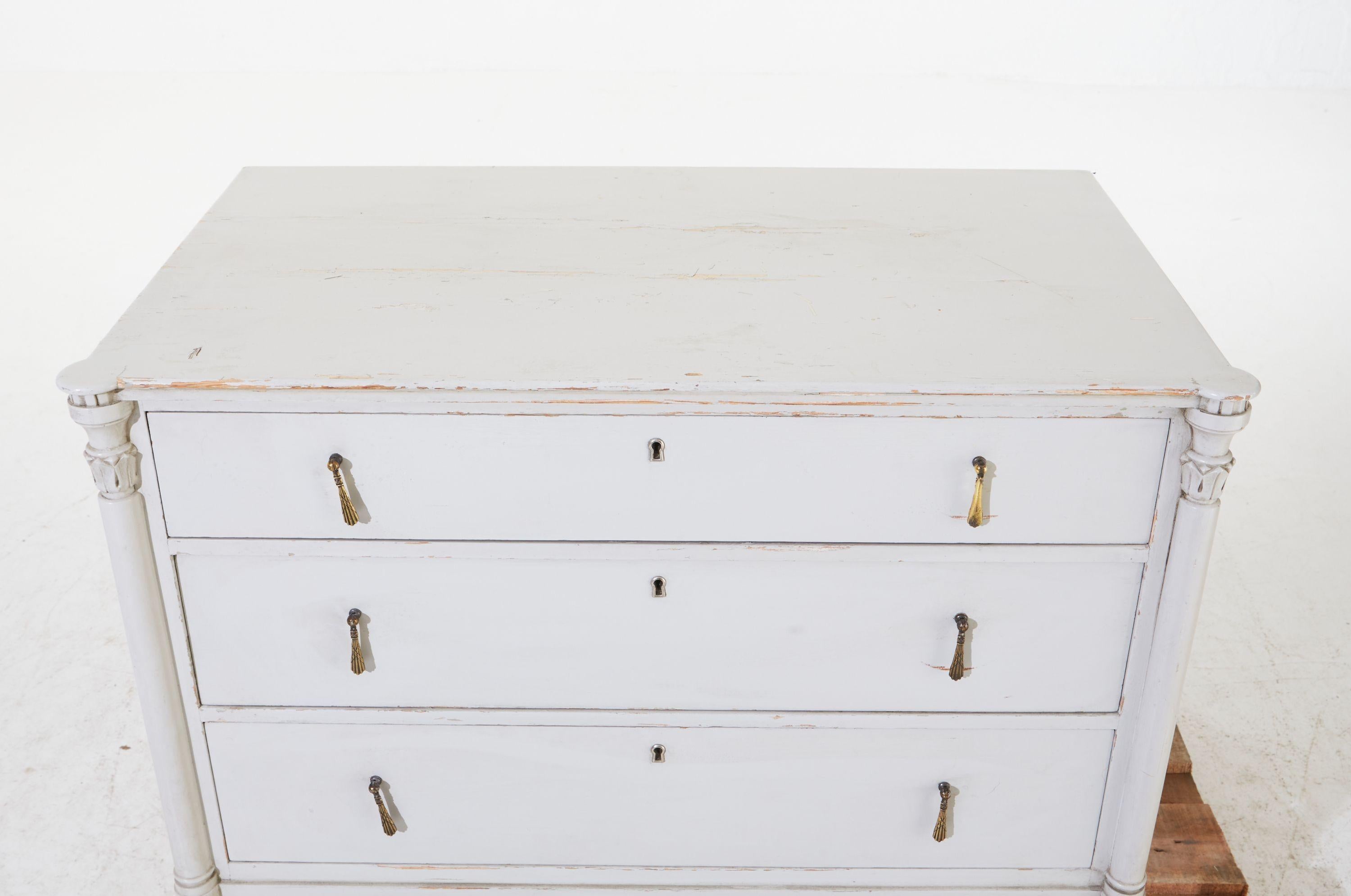 1900s grey painted Gustavian bureau with three drawers, carved legs & original brass hardware. Chest of drawers painted a calm Scandinavian creamy grey with authentic patina that only comes with gentle aging. Sturdy, strong, and so pretty with three