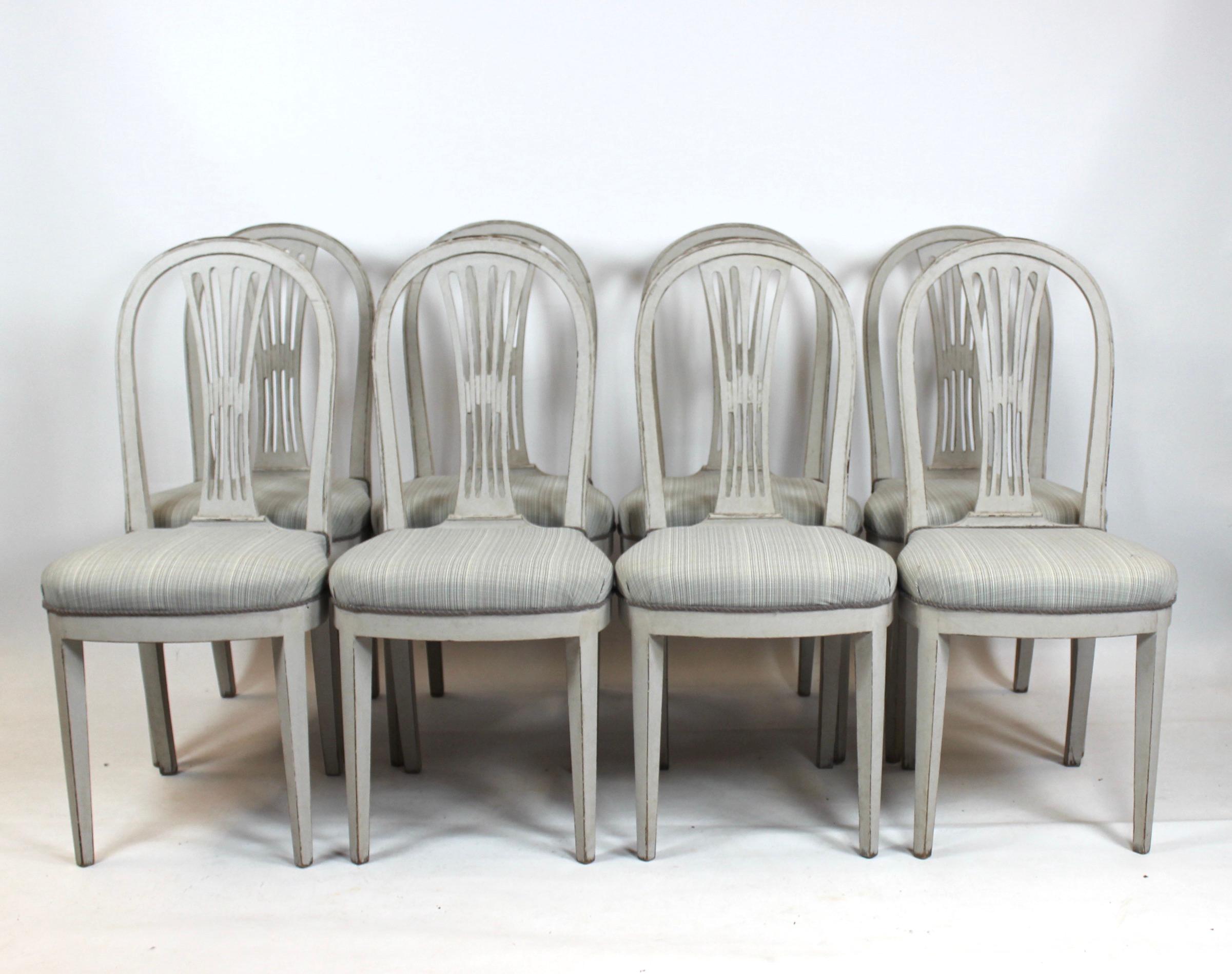 Grey painted Gustavian dining set consisting of large dining table with 4 extension plates and 8 dining chairs. All parts are in great antique condition. Each extension plate is 60cm. The chairs is 99cm in height, 45cm in width, 40cm in depth and