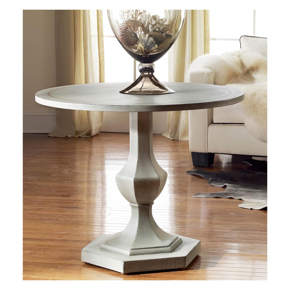 Grey Painted Neo Classic Center Table with an antique grey hand painted finish and a gold leaf accent banding to the round top. With a hexagonal column stepped pedestal base.

Dimensions: 36