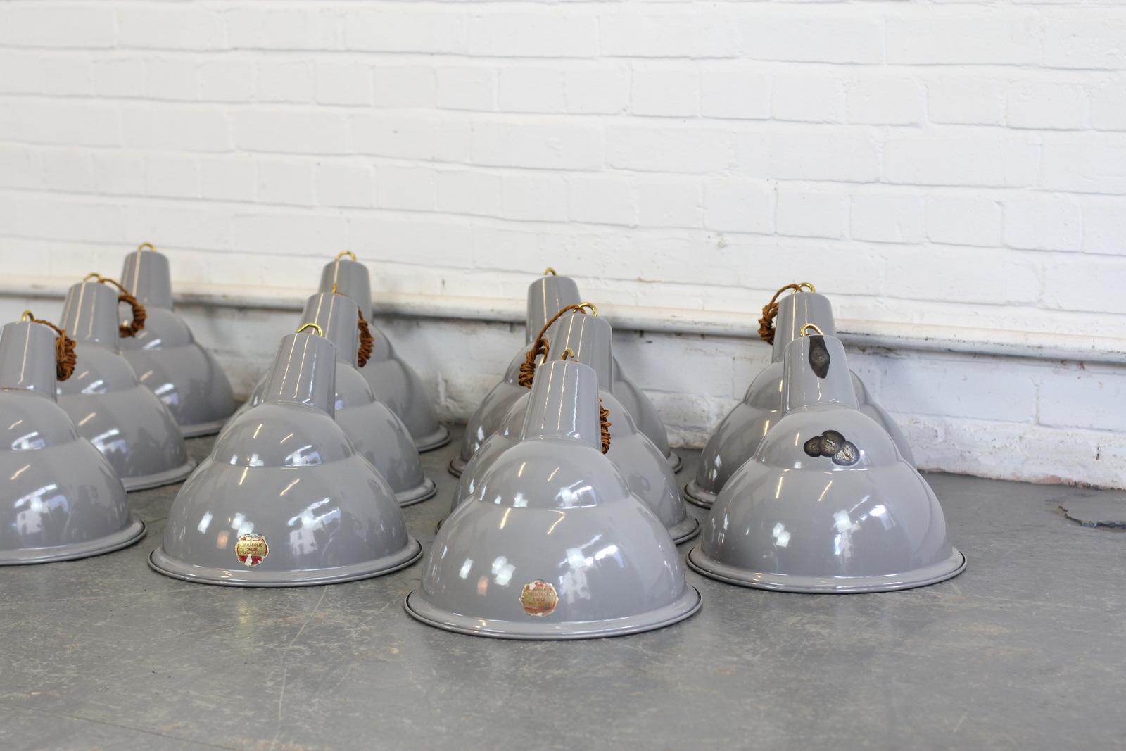 Grey Parabolic factory lights by Benjamin, circa 1950s

- Price is per light (29 available)
- Vitreous grey enamel 
- Some shades still retain their original foil badges
- Comes with 100cm of gold twist cable
- Comes with 100cm of suspension