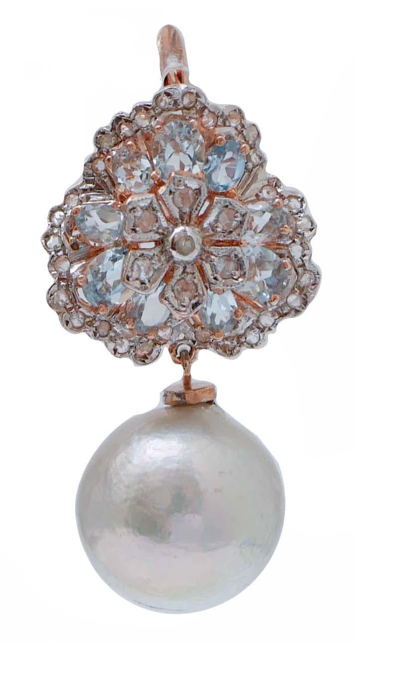 Fantastic earrings in 9 kt rose gold and silver structure mounted with a flower of diamonds surrounded by topazs and diamonds in the upper part; as pendant, a grey pearl.
These earrings were totally handmade by Italian master goldsmiths and they are