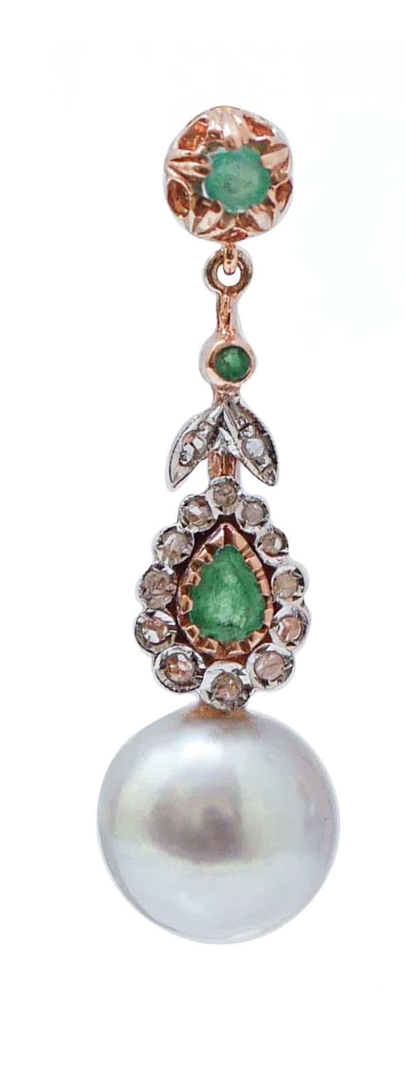 Dangle earrings in 9 kt rose gold and silver structure mounted with diamonds and emeralds along the lenght of the earring and a grey pearl as pendant.
These earrings were totally handmade by Italian master goldsmiths and they are in perfect