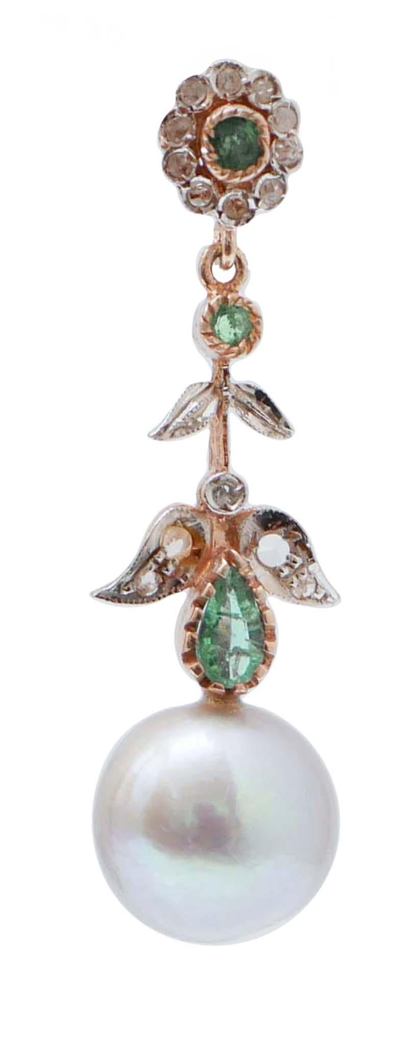 Amazing earrings in 9 kt rose gold and silver structure mounted with a flower of diamonds and an emerald in the upper part; in the middle, emeralds and leaves studded with diamonds. Below, a grey pearl.
These earrings were totally handmade by