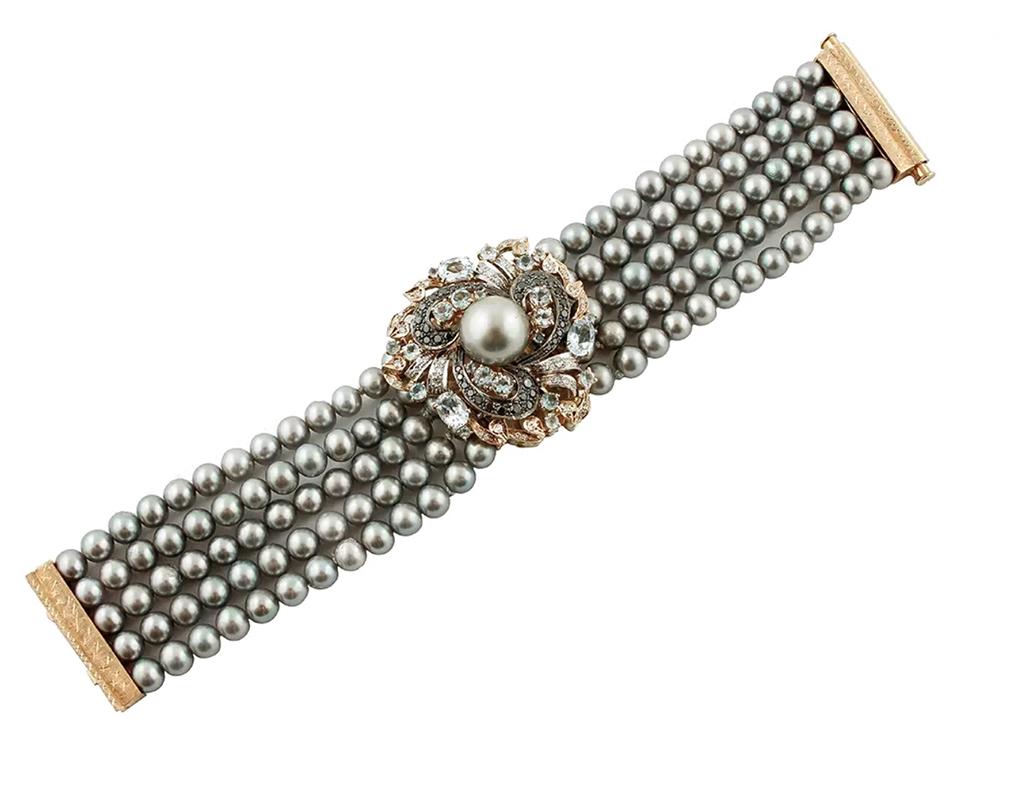 Vintage beaded bracelet realized with 5 strands of grey pearls (7mm) with a central important decoration in 14k rose and white gold structure with a central grey pearl (14mm) surrounded by decorations of white diamonds, black diamonds and