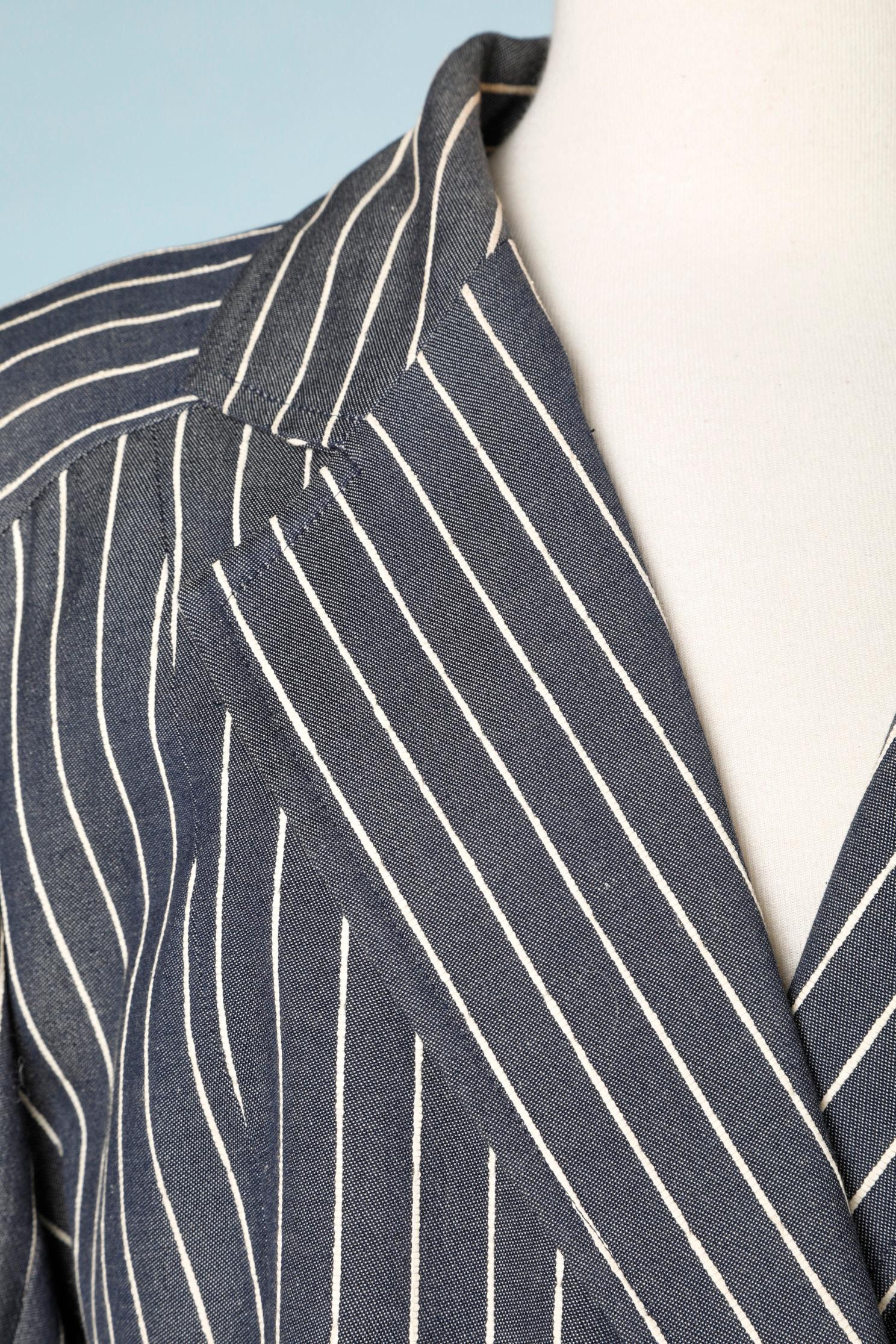 Grey pinstripe  jacket  with enamel buttons. Plain skirt. 
SIZE 38 (M) 