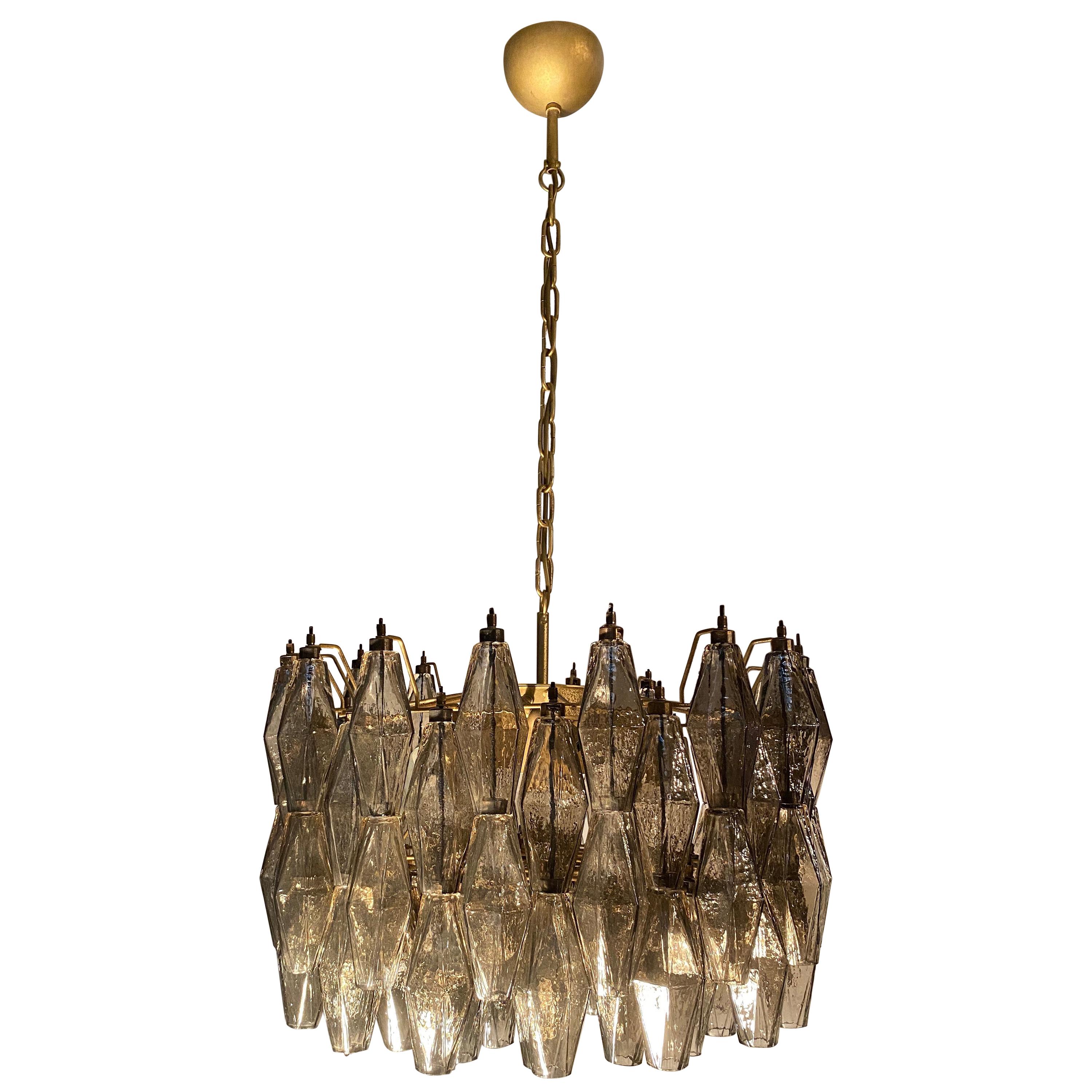 The chandelier consists of 103 hand blown grey 