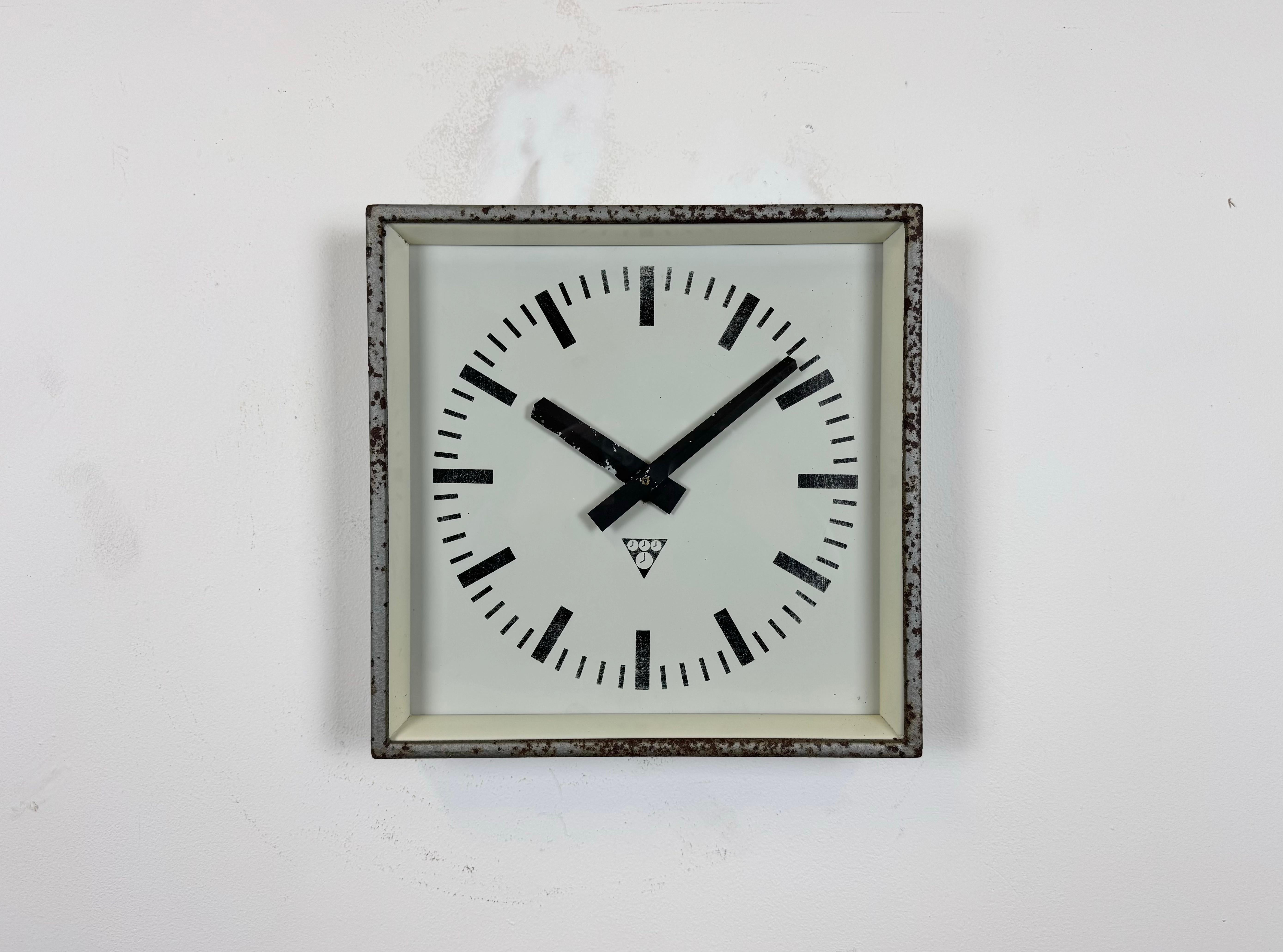 - Reloj de pared diseñado por Pragotron en la antigua Checoslovaquia durante la década de 1970 y fabricado hasta la década de 1990
- Se utilizaba en fábricas, escuelas y estaciones de ferrocarril 
- Estructura de metal gris con una interesante