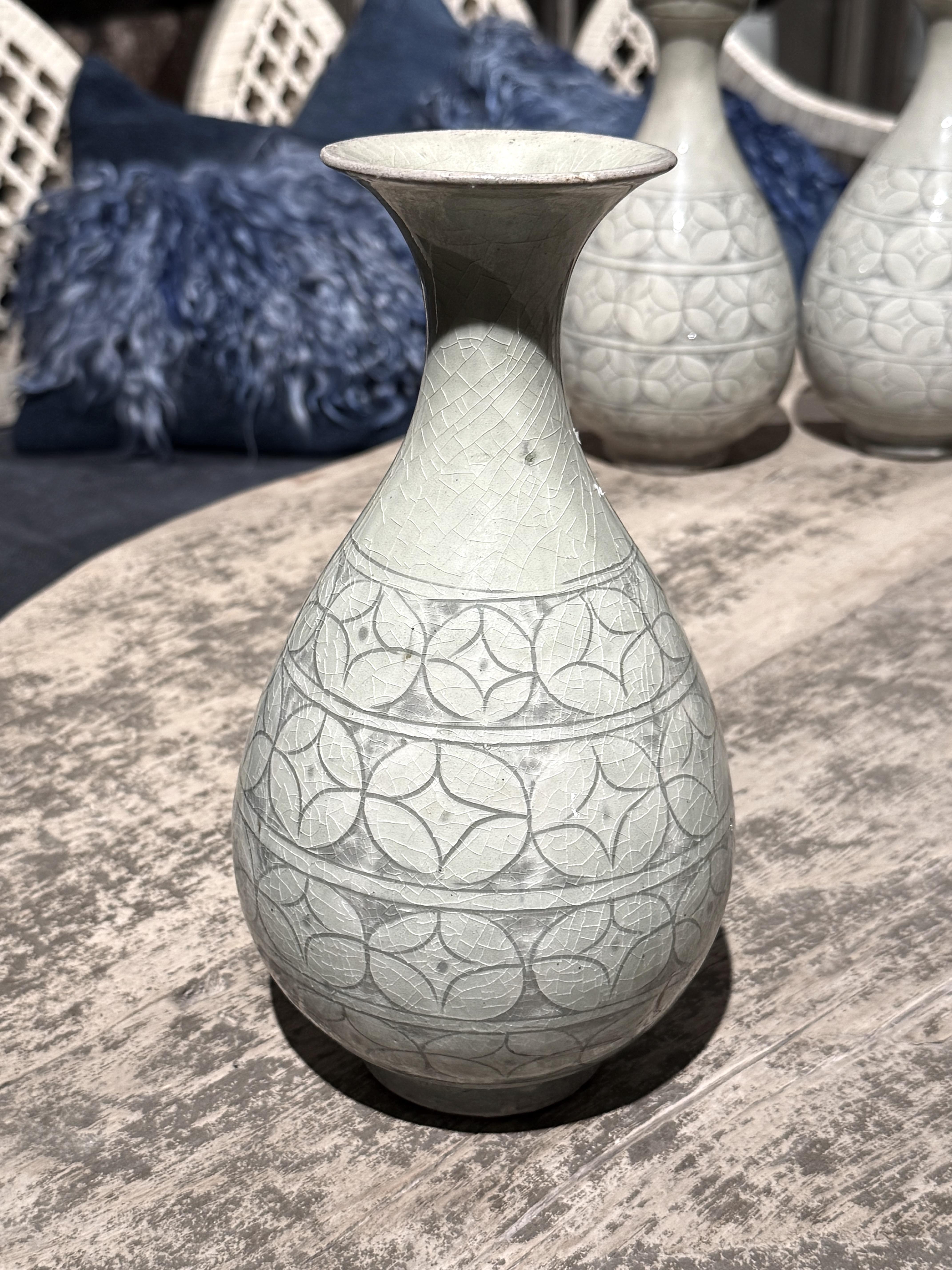 Contemporary Chinese geometric patterned grey / sage colored vase.
Tulip shape.
Horizontal bands of circular decorative pattern.
Collection of five with different shapes available and sold individually.
ARRIVING NOVEMBER