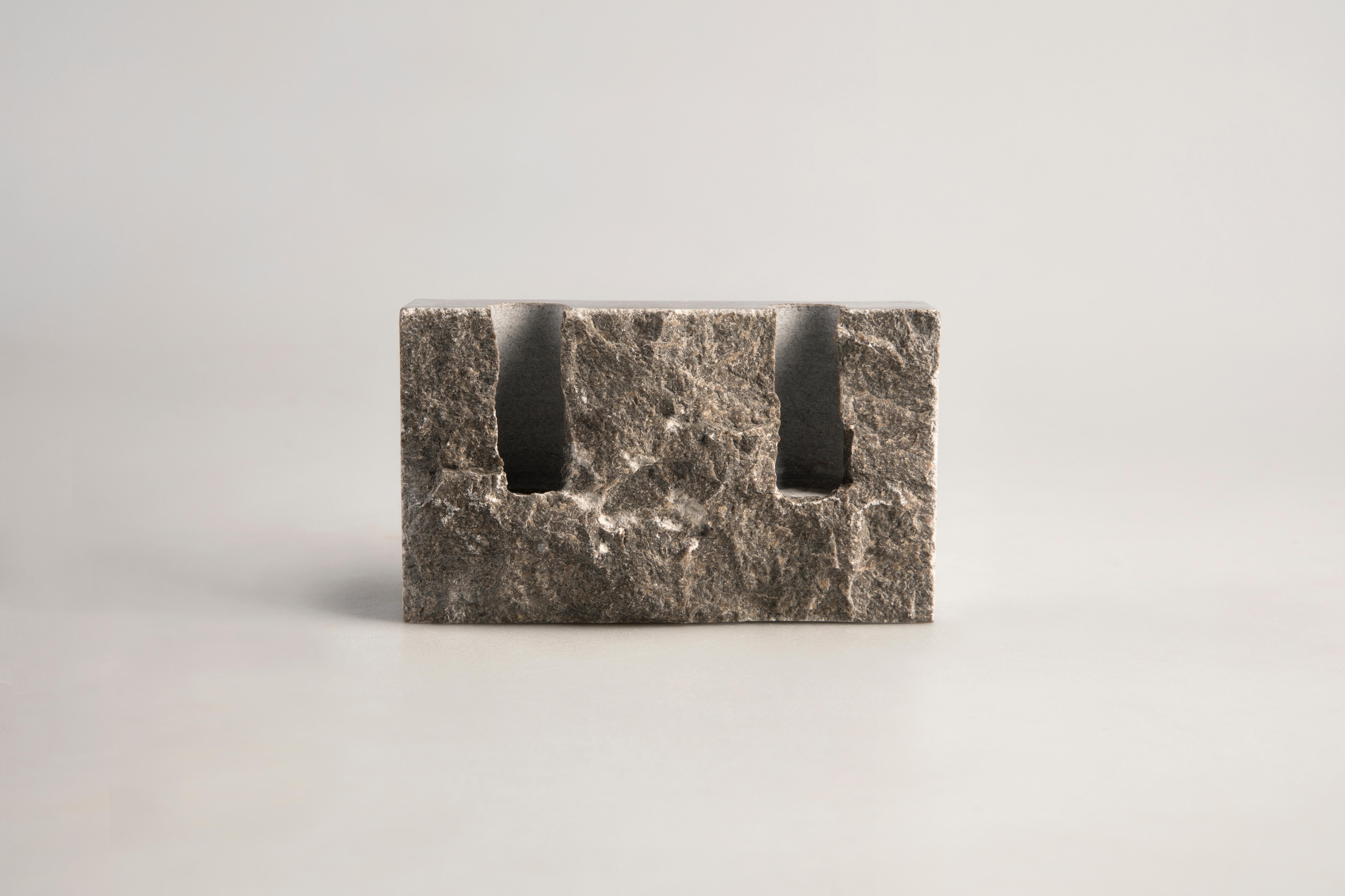 Grey Sant Vicenç sculpted candleholder by Sanna Völker
The size of the candleholder is 15 x 3 x 9 cm, designed to be used with drip-less candles of size Ø22 mm. 

All pieces are handcrafted in natural stone. This results in variations in color
