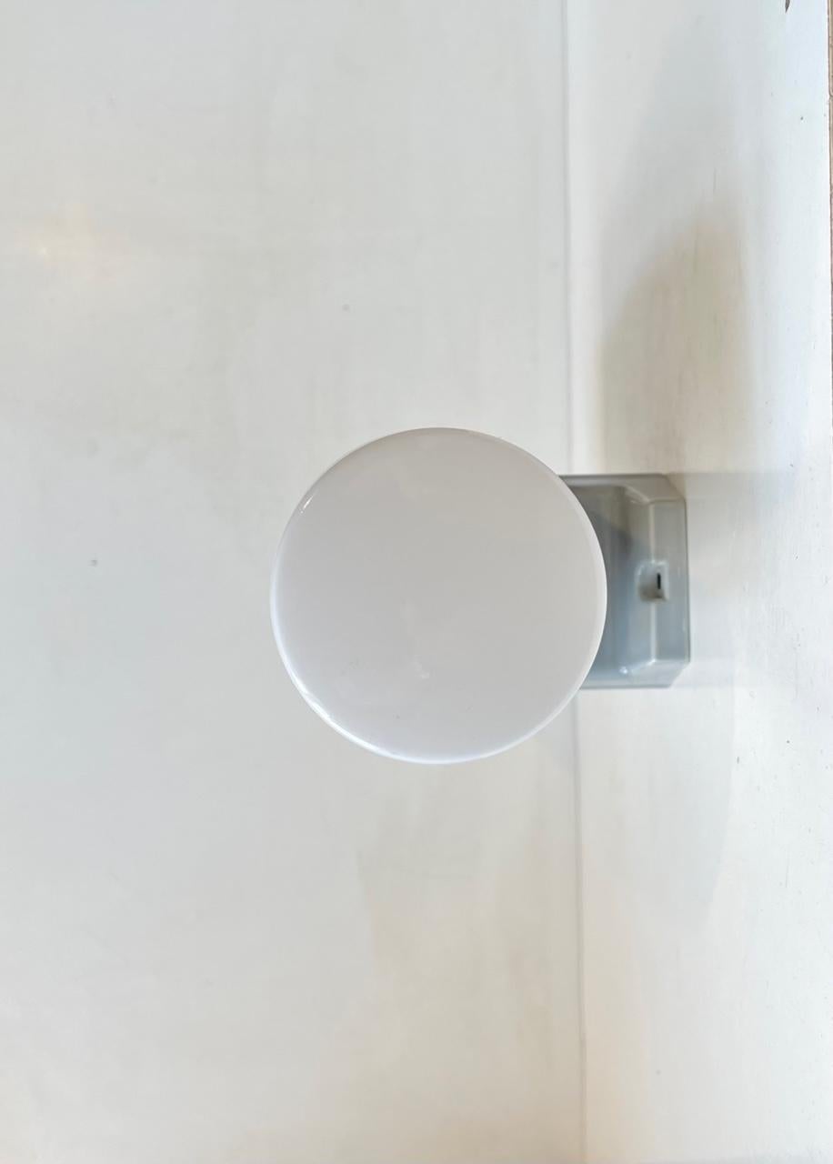 Large dual Wall sconce suitable as bathroom or outdoor lighting. Designed by Prince Sigvard Bernadotte for the swedish company Ifö during the 1960s. Grey glazed porcelain mount with 2 white opaline glass shades. 2 way mount - vertical or horizontal.