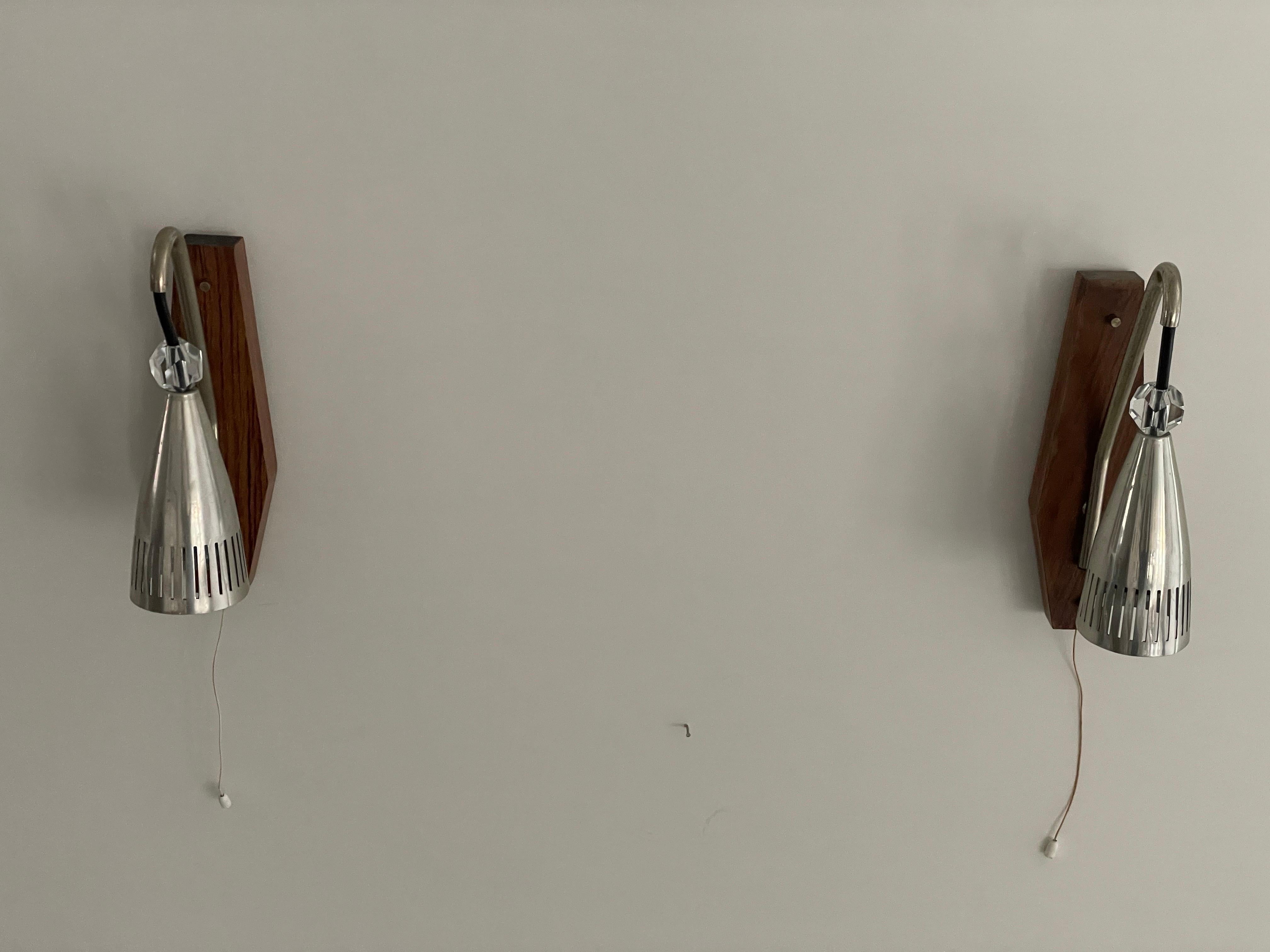 Grey Shade Danish Sconces with Wood Base, 1960s, Denmark

Lamps are in very good condition.

These lamps works with E14 standard light bulbs. 
Wired and suitable to use in all countries. (110-220 V)

Dimensions:
Height: 26 cm
Width: 16 cm
Depth: 7 cm