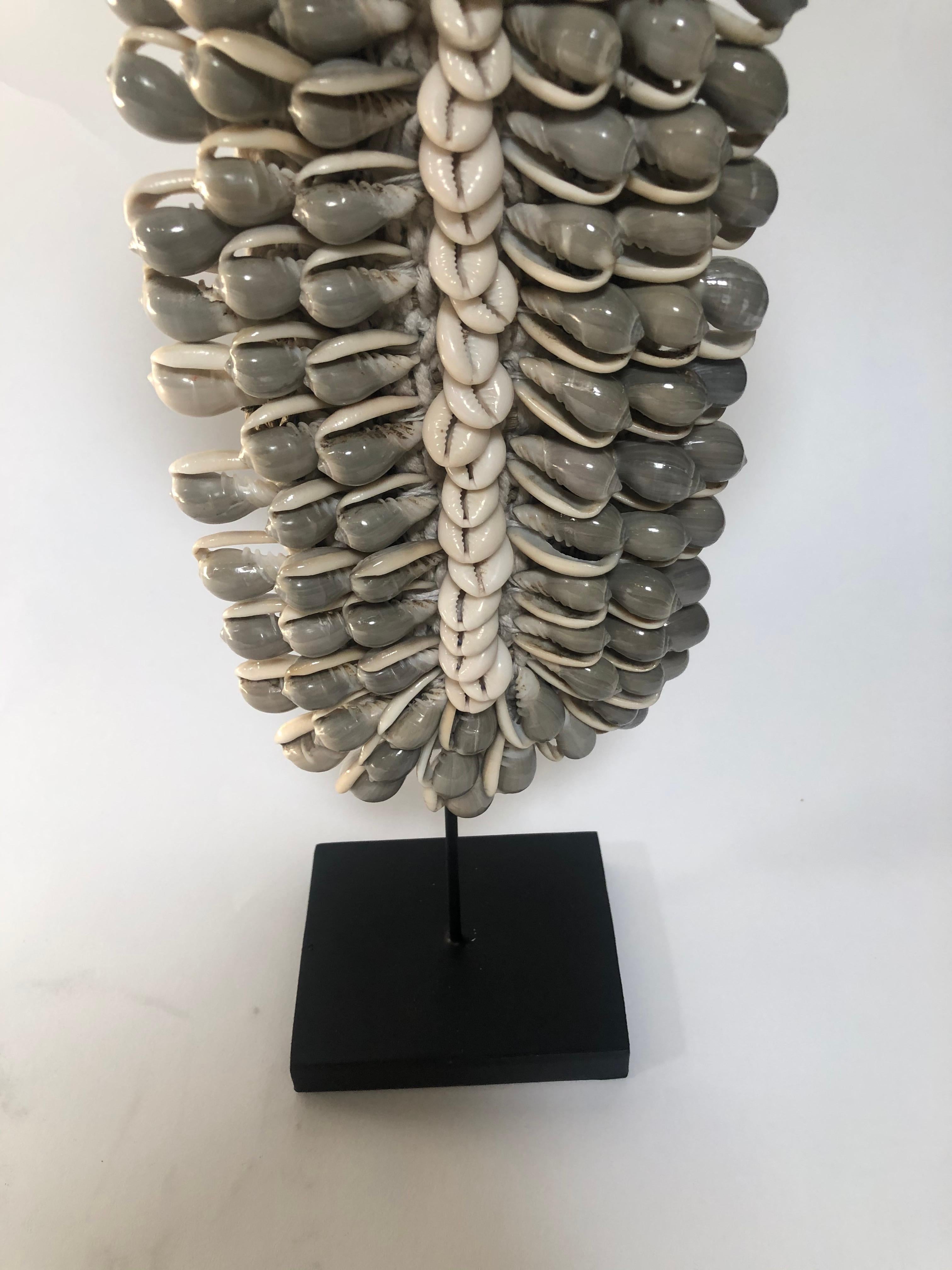 Detailed shell necklace on stand from Asia.