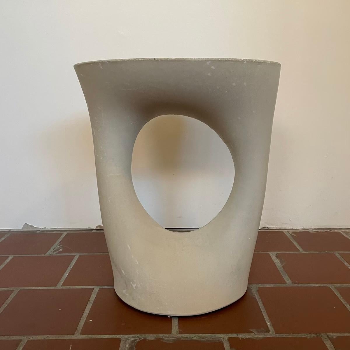 This piece is a factory 2nd. This piece has a few very minor scuff marks and some small air bubbles that were patched with plaster. Overall it's in excellent condition.

Industrial, organic and sculptural, the Kreten side tables are concrete