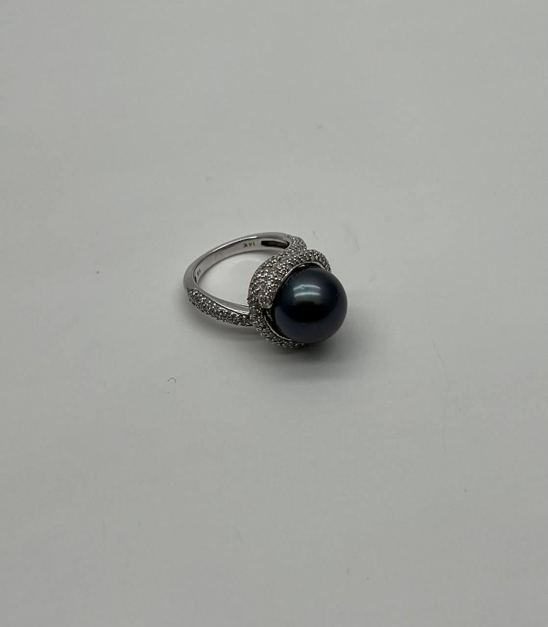 Elegant and Timeless. Set with a Lustrous Black Tahitian Pearl. Accented by Intricate White Gold Detailing. 14K White Gold. 1.65 CTW Diamonds. Natural Pearl.