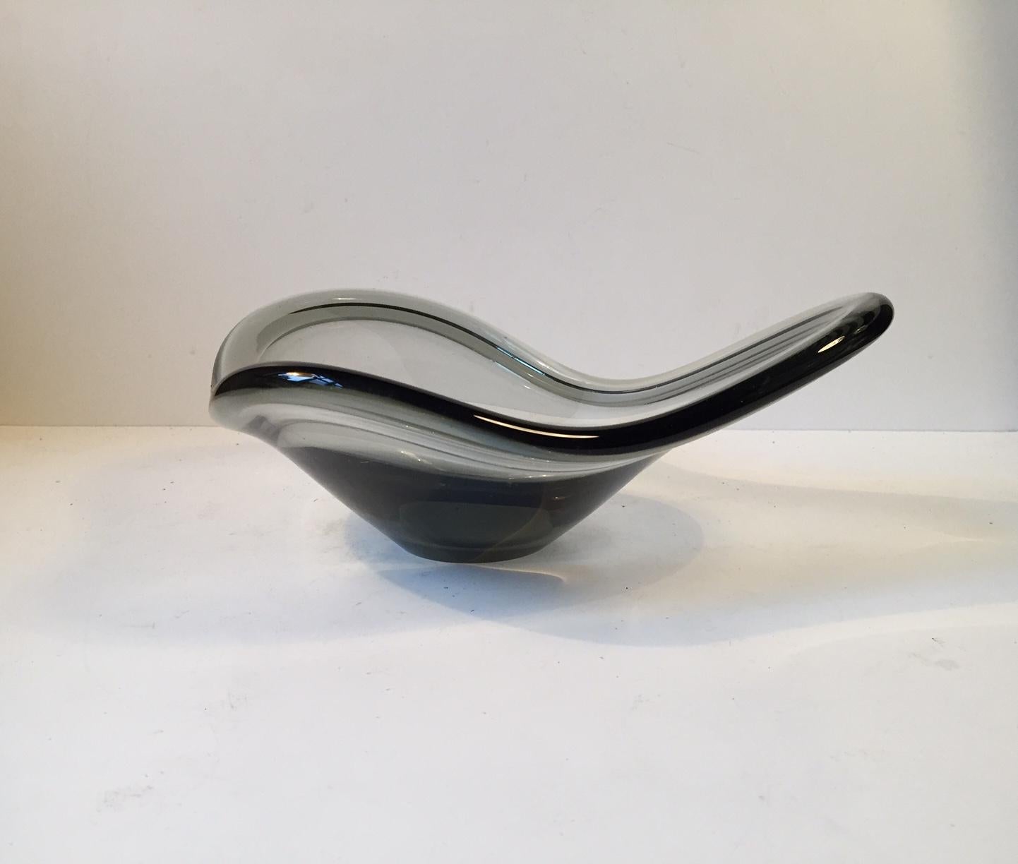 Hand blown smoke grey Holmegaard glass bowl in a three-lobed organic shape. It was designed by Per lütken in 1962. This is an early example and it is signed Pls by hand to the base.
 