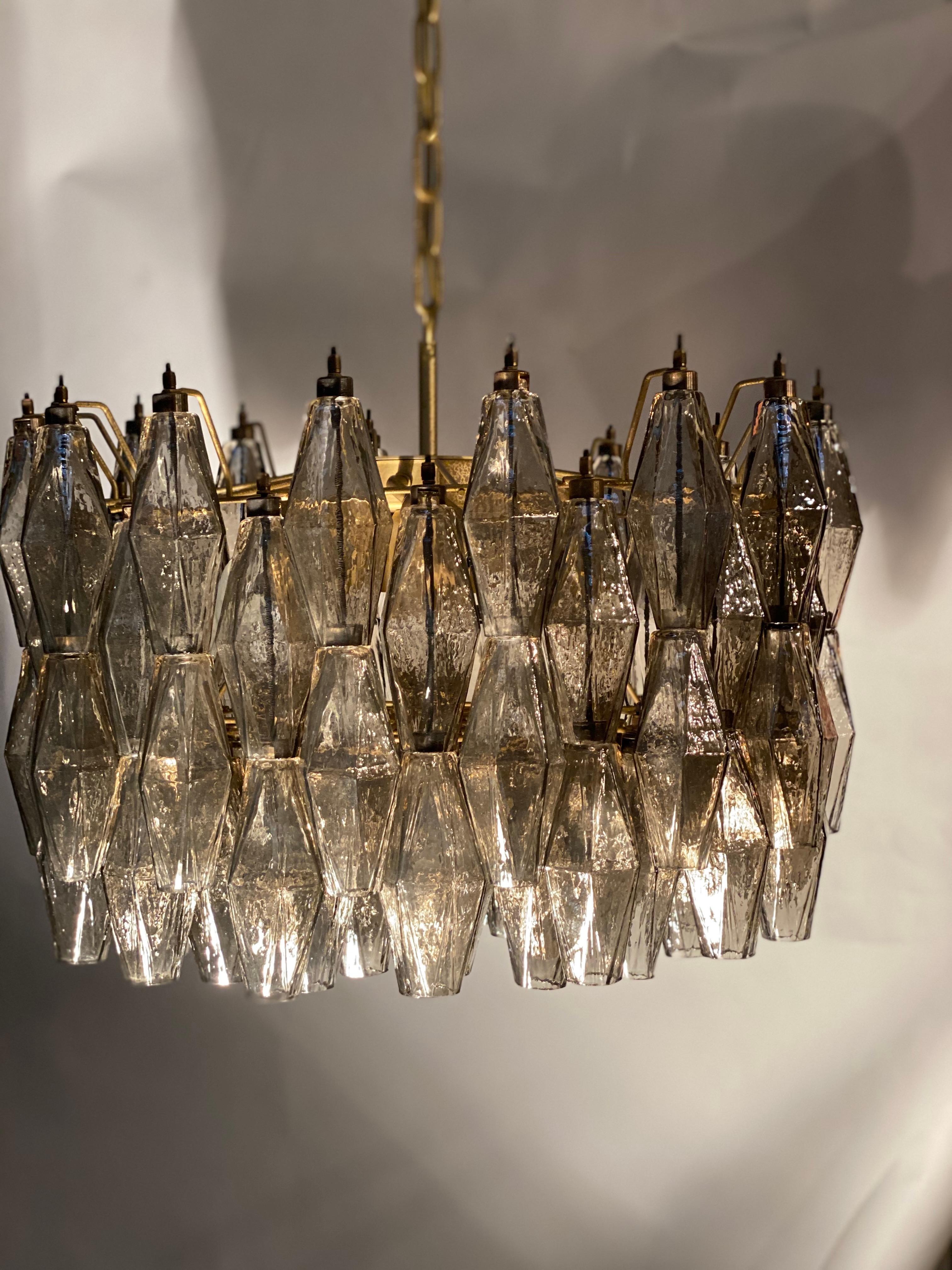 The chandelier consists of 103 hand blown grey 