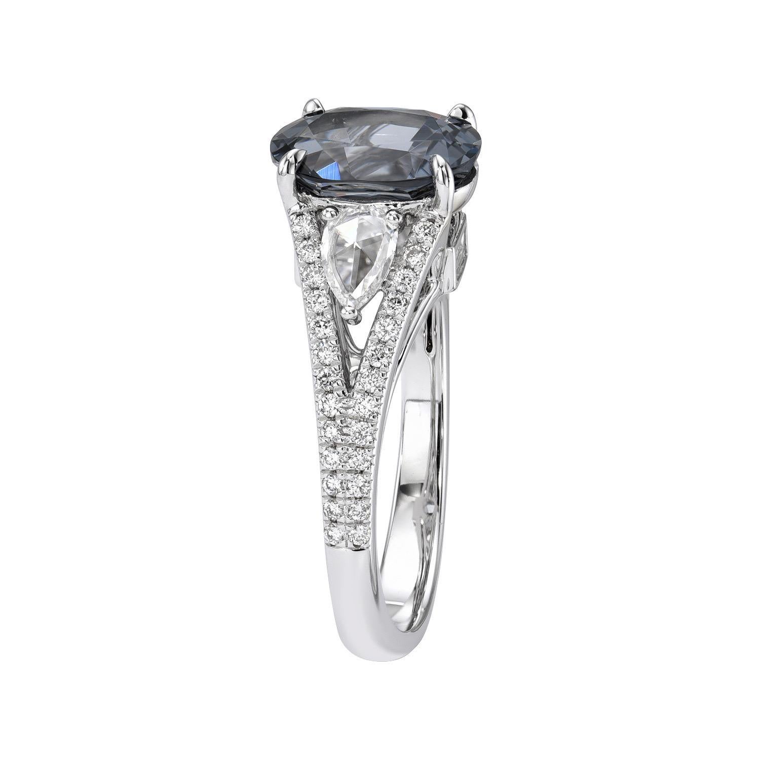 Very unique 2.49 carat Grey Spinel oval, 18K white gold ring, decorated with a total of 0.09 carat baguette diamonds, a pair of 0.23 carat rose-cut pear shape diamonds, and a total of 0.24 carat round brilliant diamonds.
Ring size 6.5. Resizing is