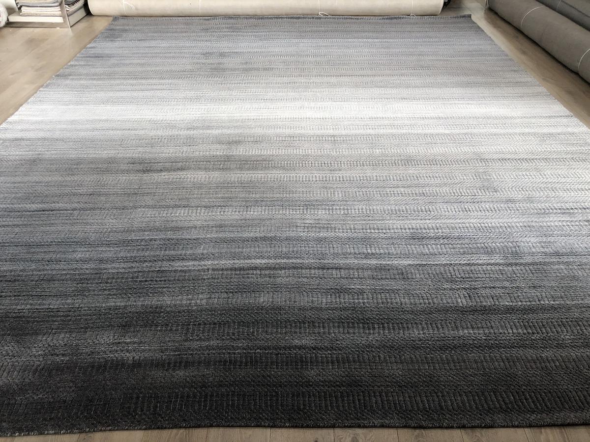 From the popular Meadow Collection, a subtly-patterned large area rug in shades of grey. The interplay of light and dark makes this rug a visual treat in its own right as well as a foundation on which to build. Wool/viscose/cotton construction