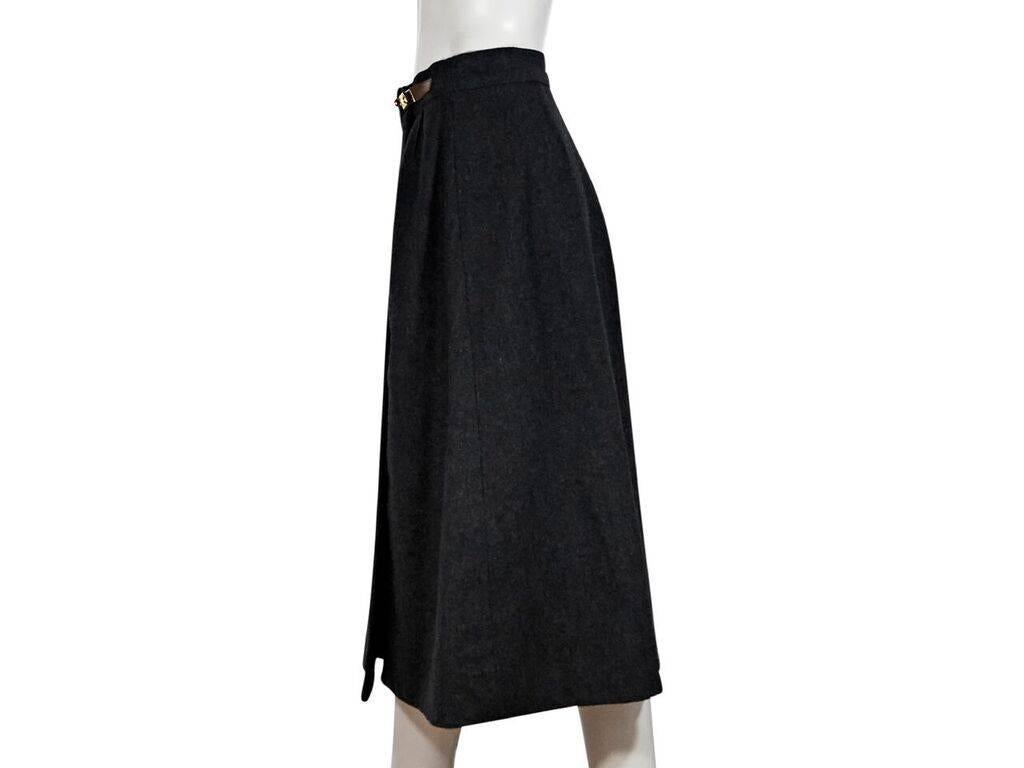 Product details:  Vintage grey wool long skirt by Hermes.  Banded waist with Kelly belt details.  Double twist-lock closure.  Flared hem.  Goldtone hardware.  Label size FR 42.  32