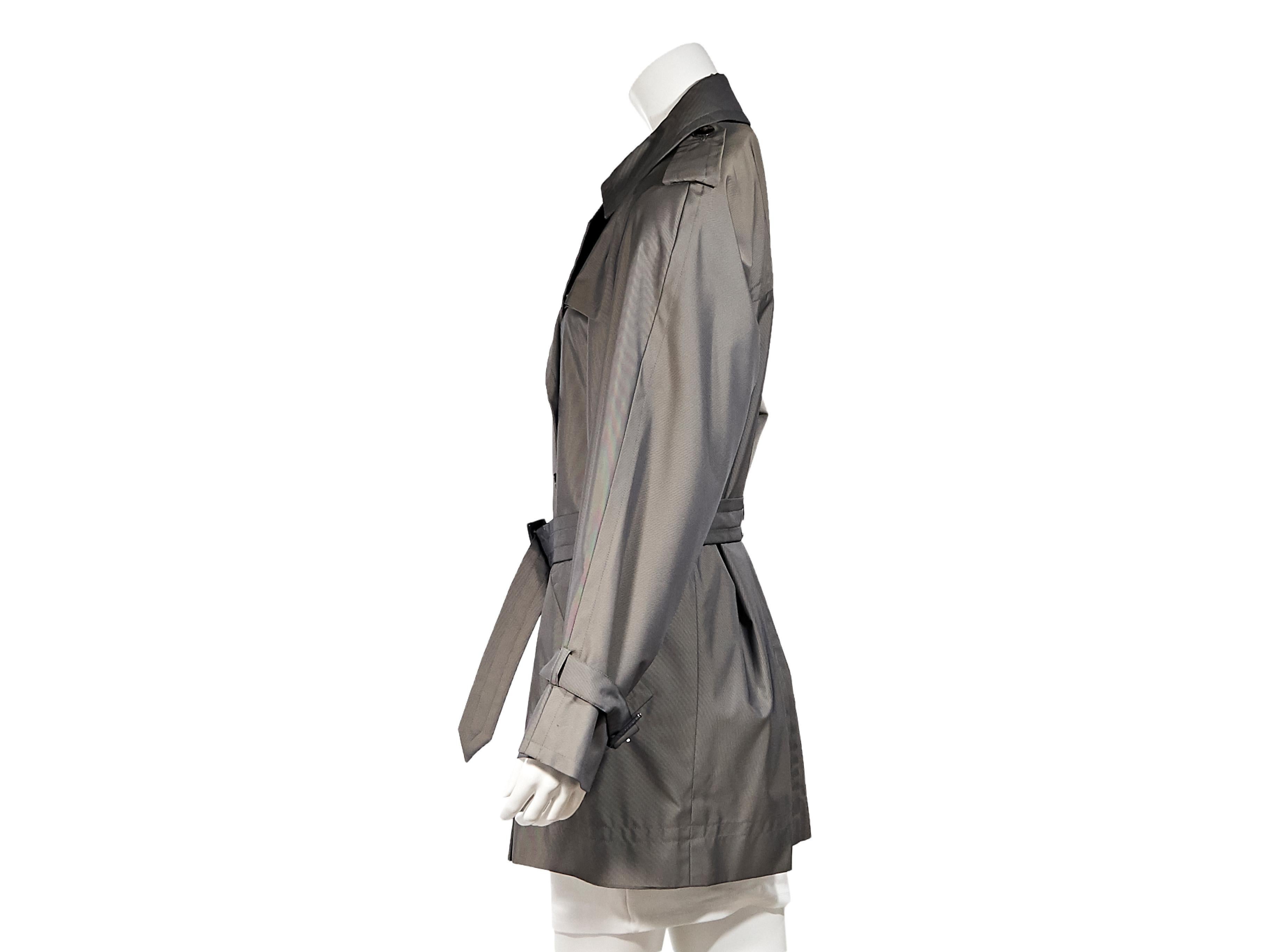 Product details:  Vintage grey trench coat by Yves Saint Laurent Rive Gauche.  Shoulder epaulettes.  Notched lapel.  Double-breasted button-front closure.  Adjustable belted waist.  Waist slide pockets.  Label size FR 42.  34