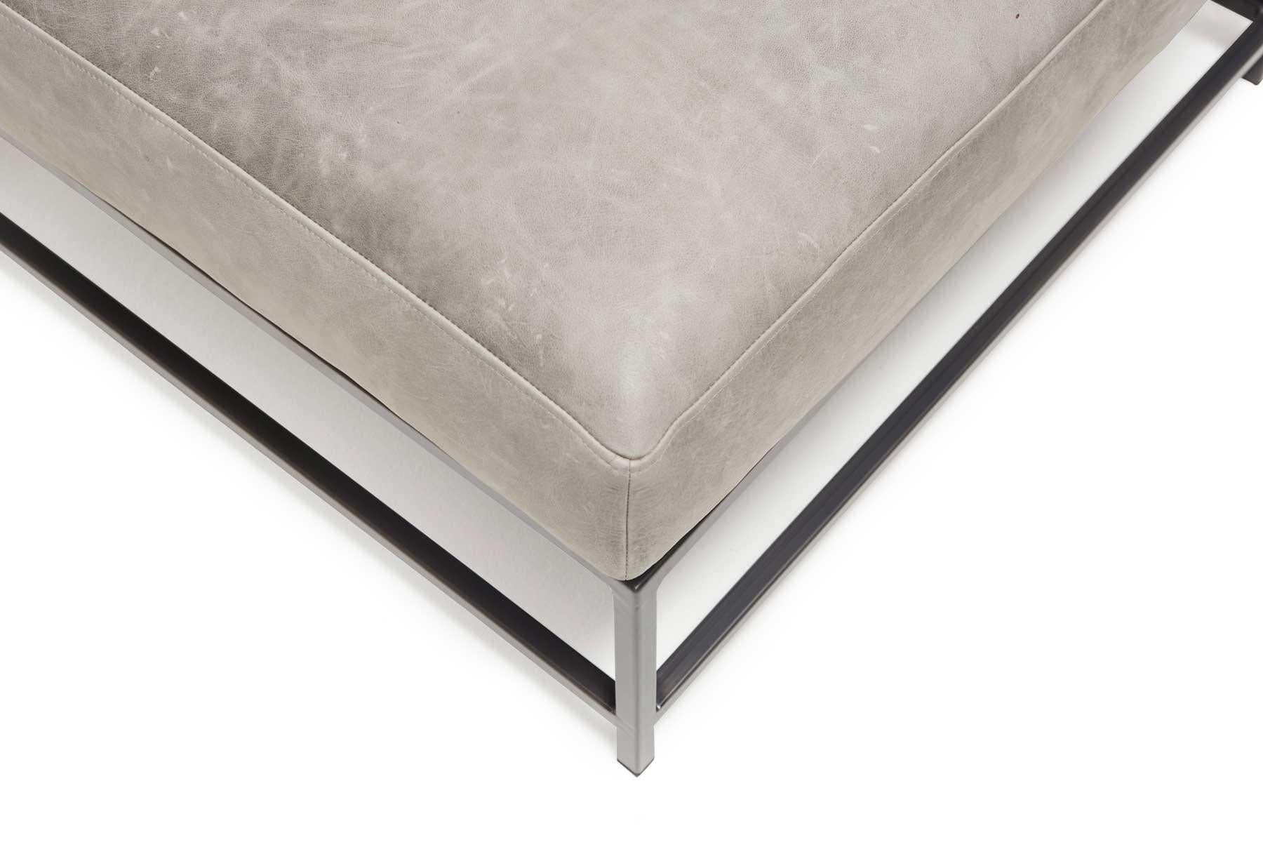 The ottoman from Stephen Kenn's Inheritance Collection is a versatile piece to add a lounge element to your seating arrangement.

This ottoman is upholstered in a light grey waxed leather from the Burnham collection by Moore & Giles. The foam