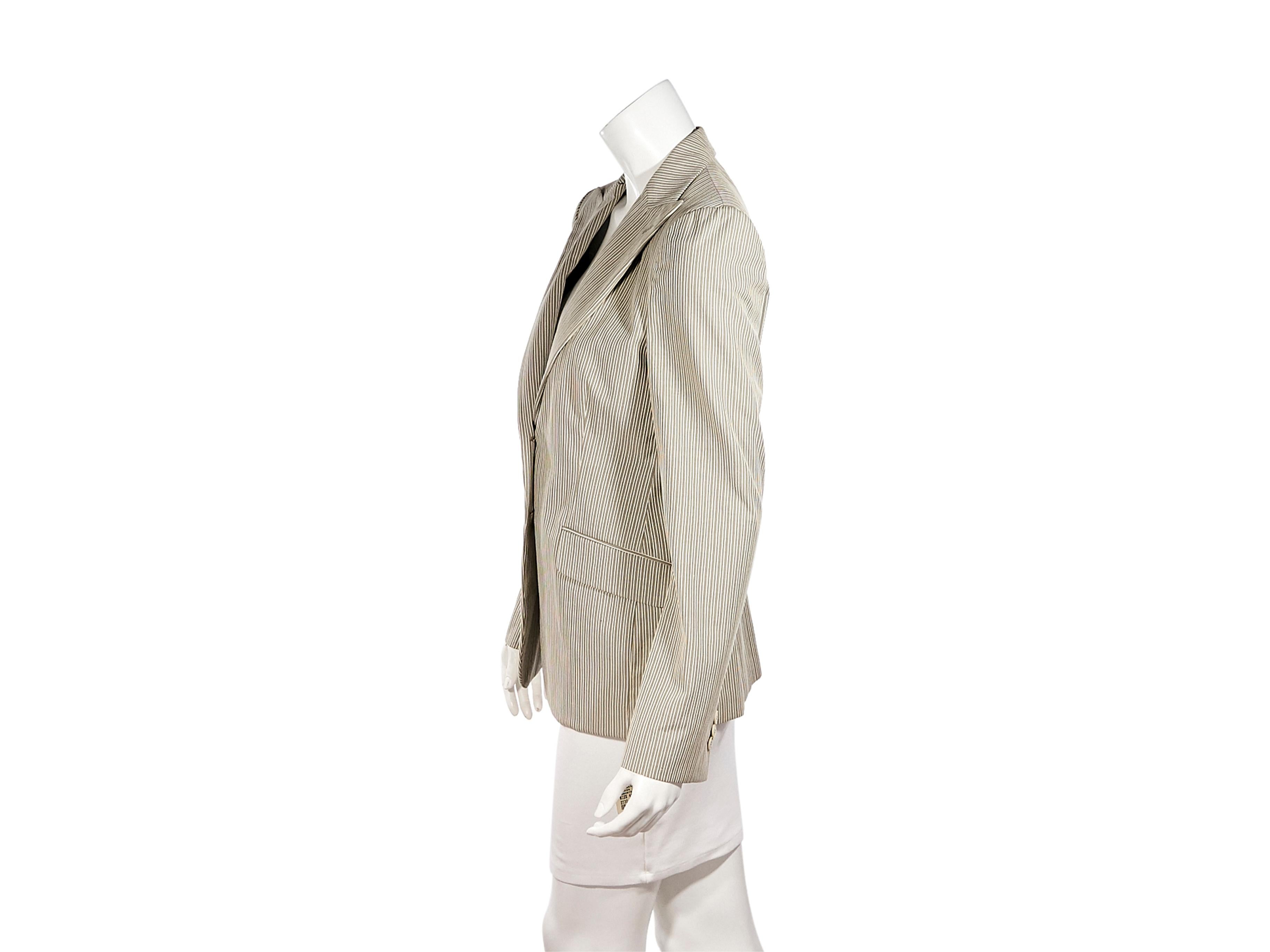Product details:  Grey and white striped cotton blazer by Loro Piana.  Peak lapel.  Long sleeves.  Three-button details at cuffs.  Button-front closure.  Waist flap pockets.  Center back hem vent.  39