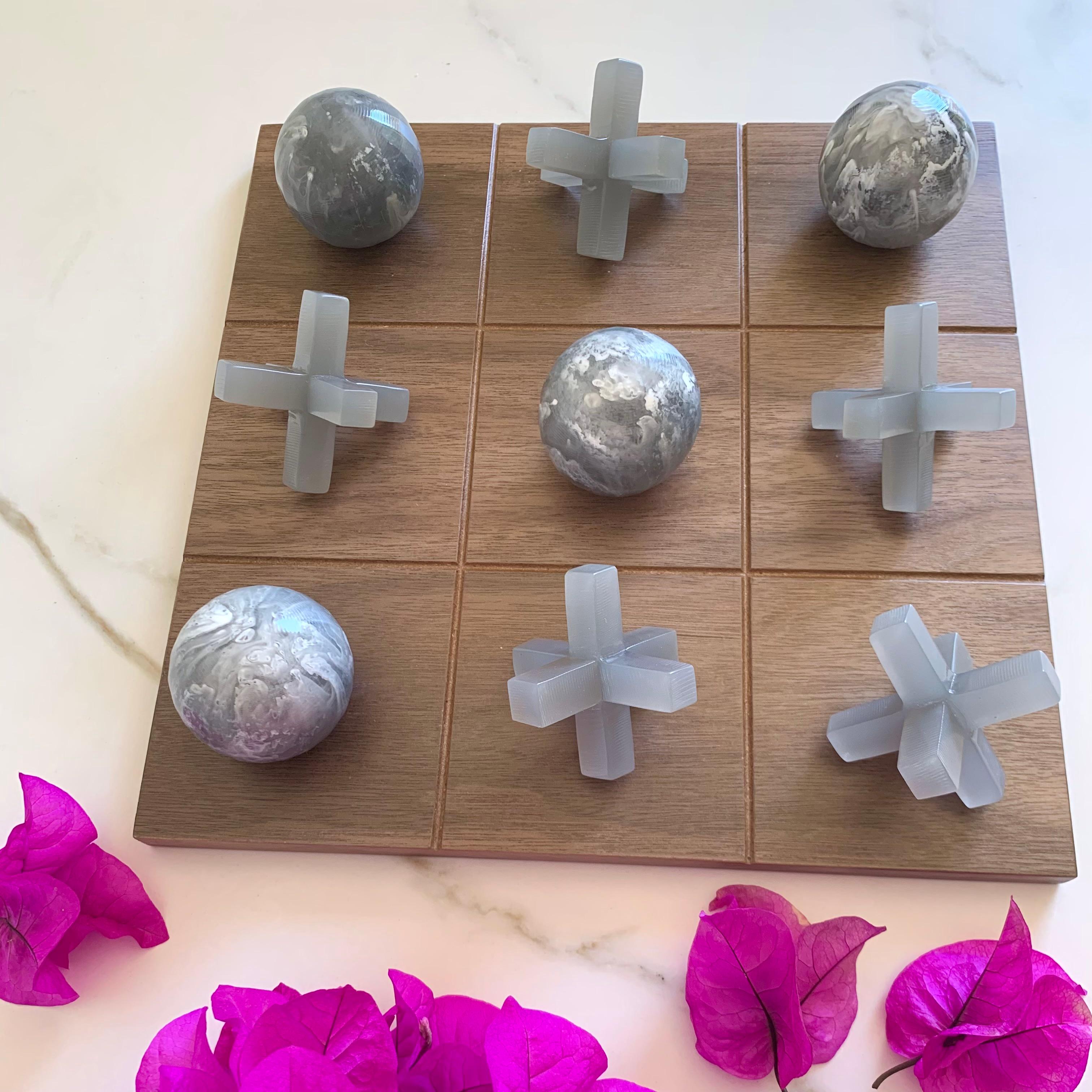 Our Tic Tac Toe is a beautiful, modern and fun take on the classic game. The three dimensional pieces are handmade in grey with white marbled texture & grey , the board is made of oak wood veneer. It will be the coolest statement piece on any coffee