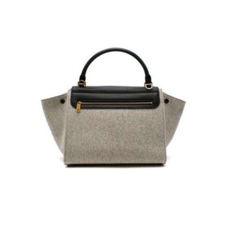 Celine Grey wool-felt & black leather Trapeze bag
 
 
 
 - Phoebe Philo era Celine
 
 - Iconic Trapeze shape with black leather flap opening, handle and strap contrasted with sturdy wool felt body in heather grey
 
 - Opens to leather-lined interior