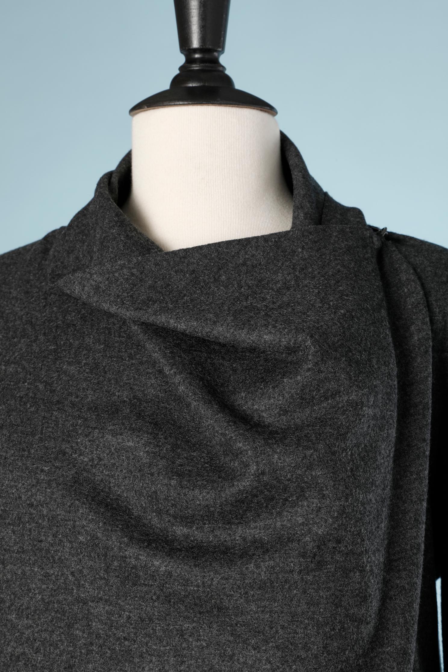 Grey wool jersey cardigan with asymmetrical cut. Close with one hook&eye on a left side on the top front. Small suede patch behind the hook. row cut on all edge except the end of the sleeves 
