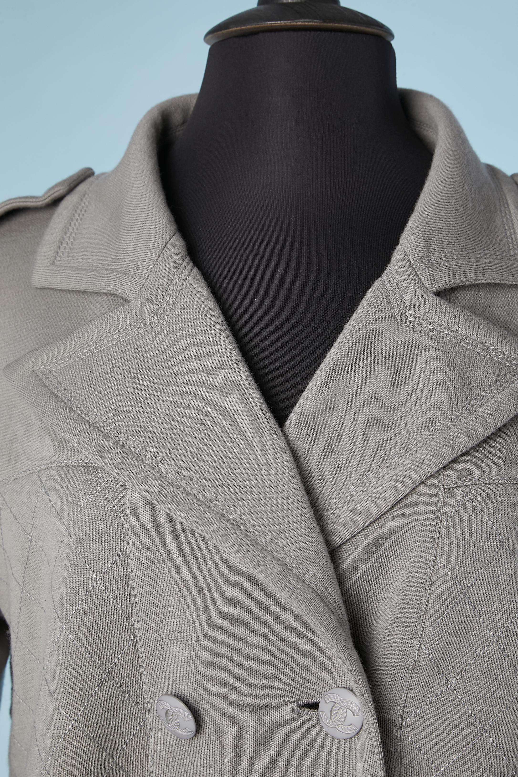 Grey wool jersey trench-coat. Branded button. Top-stitched on some parts. No lining and inside piping. 
SIZE 40 